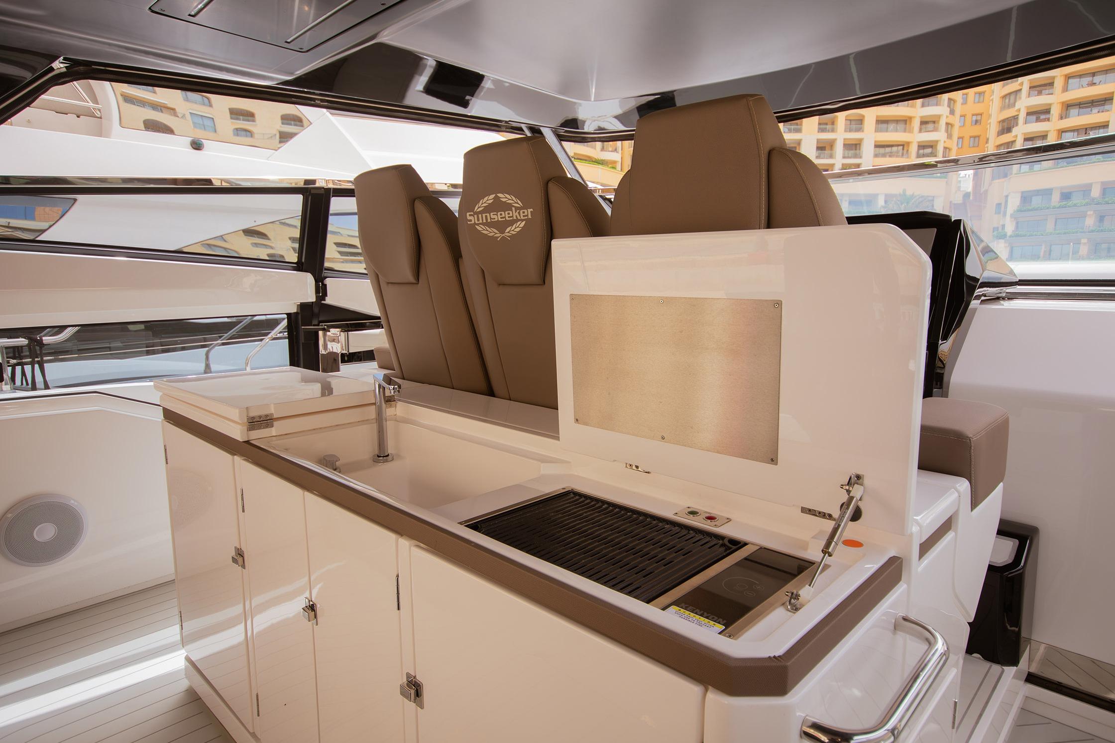 Interior of 2024 Sunseeker Superhawk 55 yacht with modern seating and kitchenette.