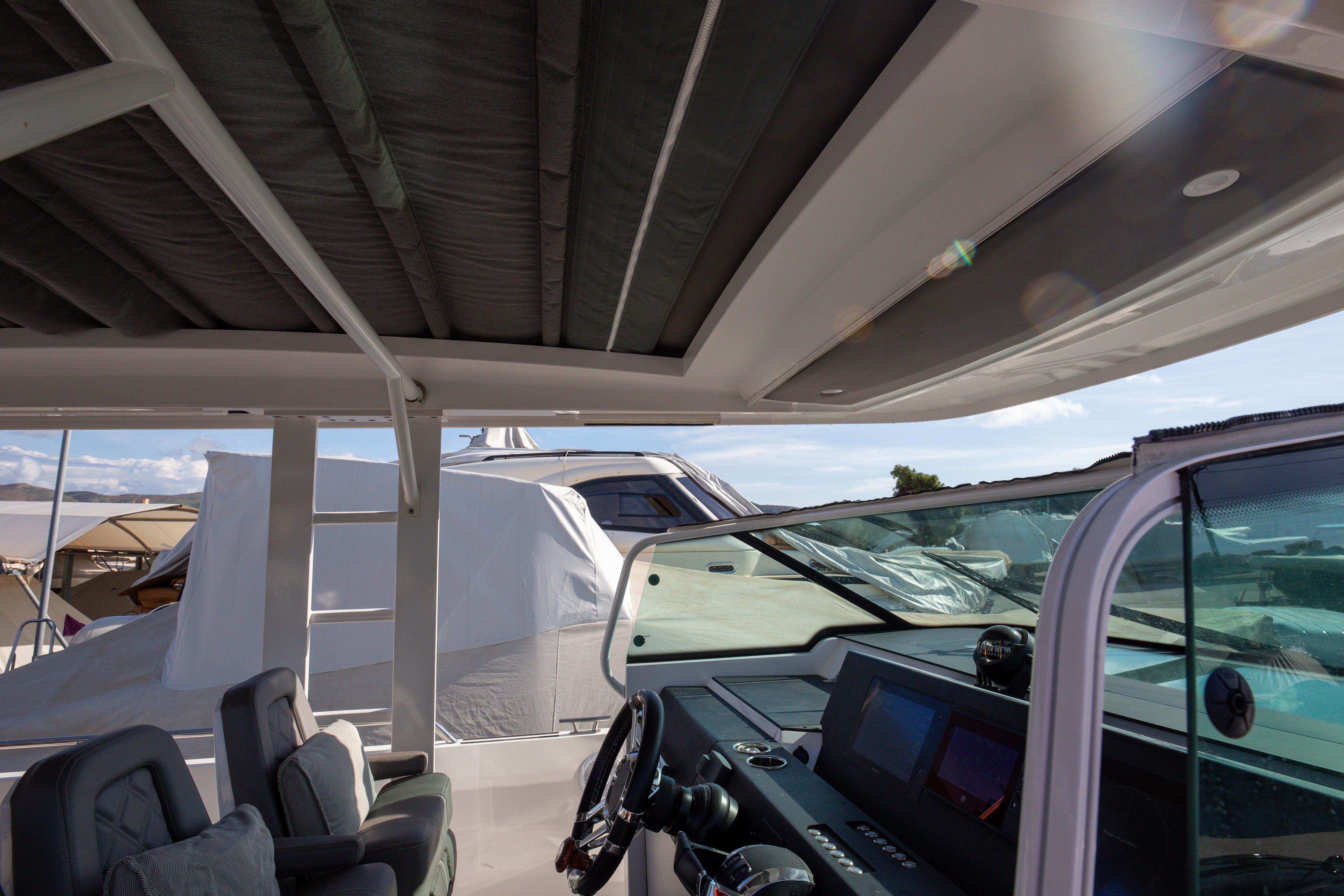 Interior view of Axopar 37 Sun-Top boat with modern dashboard and seating.