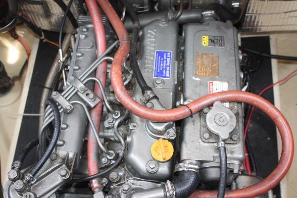 Engine room of a 1985 Nordic Tug 26 with visible hoses and components.