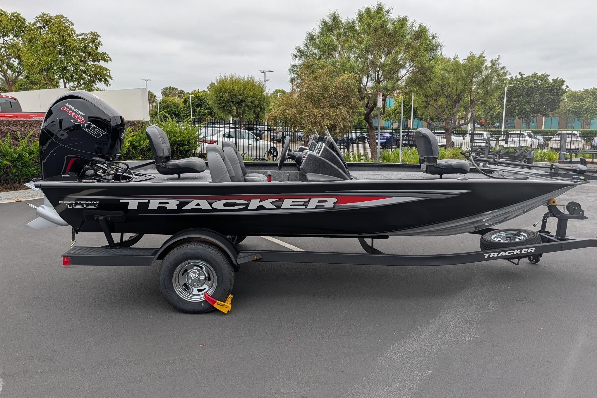 2026 Tracker Pro Team 195 boat on trailer, parked outdoors, showcasing sleek design and modern features.
