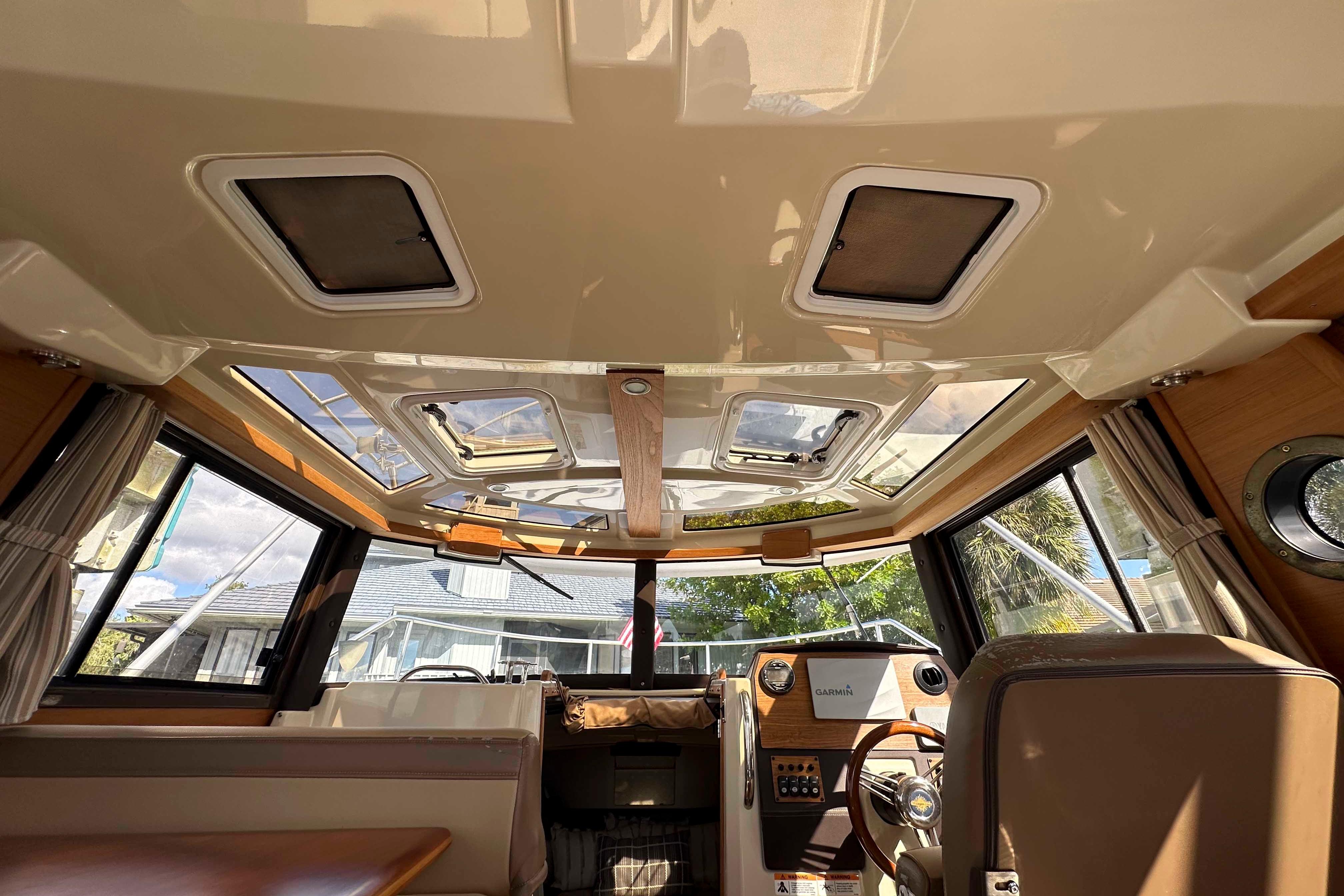 Interior view of 2020 Ranger Tugs R-23 boat, featuring helm and panoramic windows.