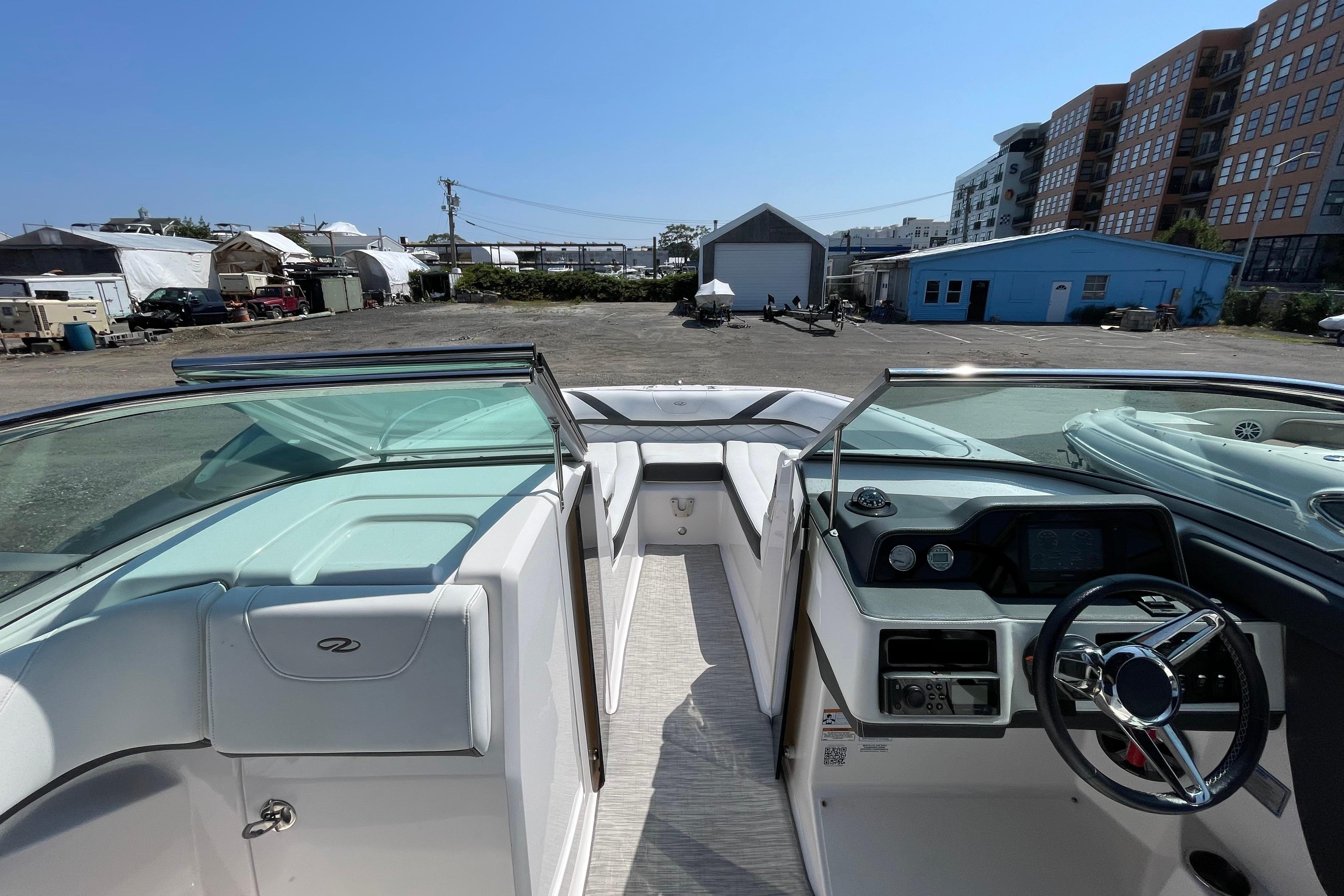 2018 Regal 26 OBX boat interior with steering wheel and dashboard, parked in a marina.