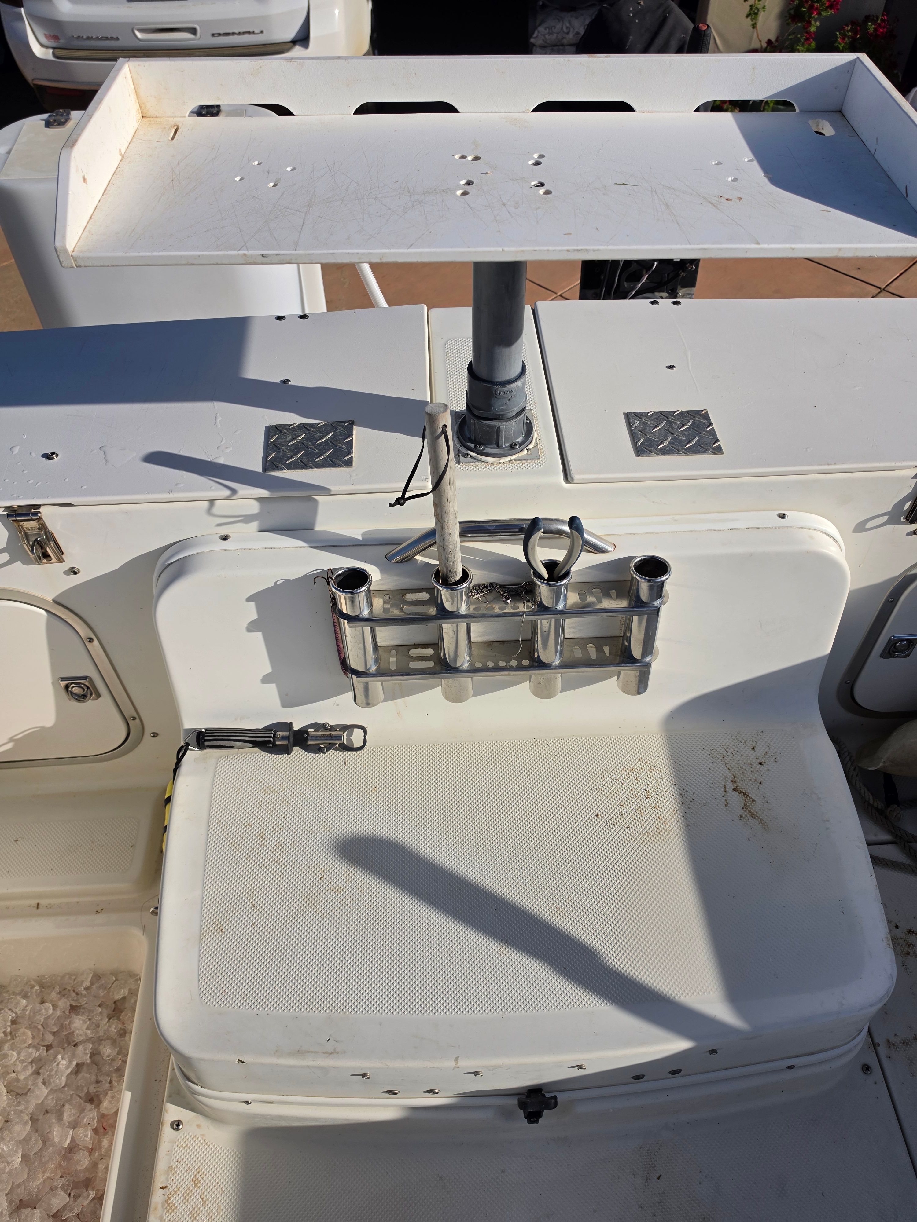 The image shows the cockpit of a 2001 Bayliner 2352 Trophy Walkaround with fishing rod holders.