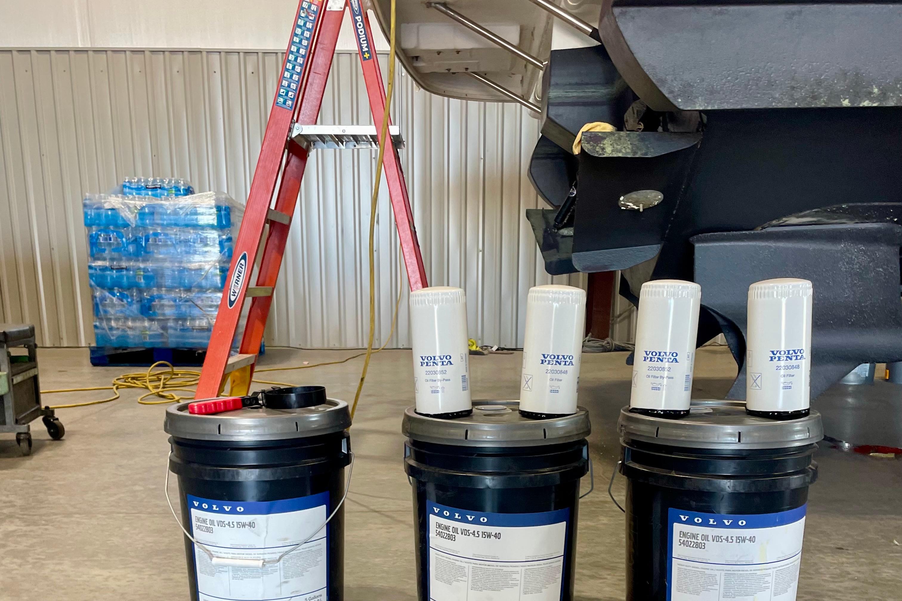 Volvo Penta engine oil containers and filters near a 2011 Cruisers Yachts 390 Sports Coupe.