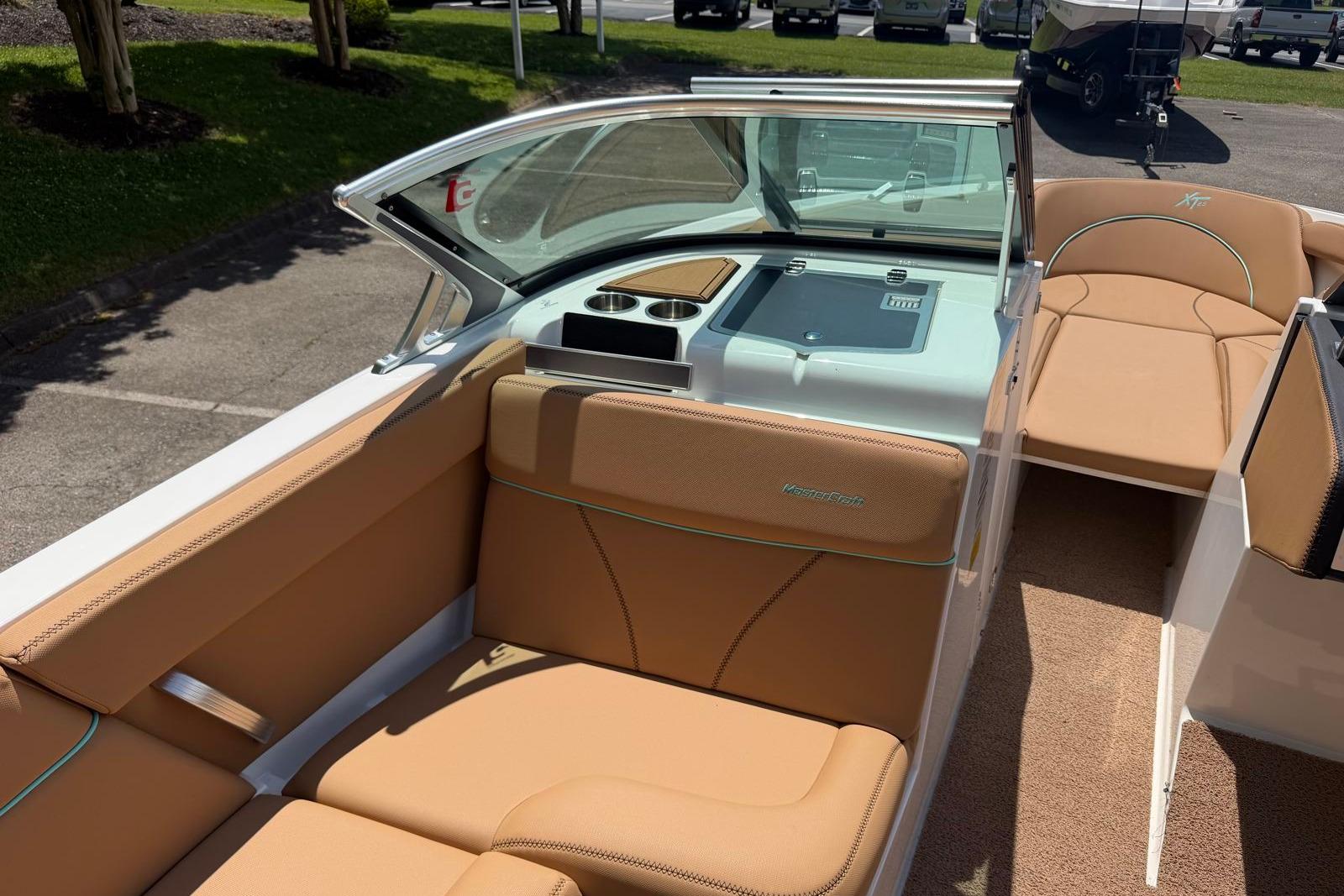 2020 MasterCraft XT25 boat interior with tan leather seating and modern dashboard.
