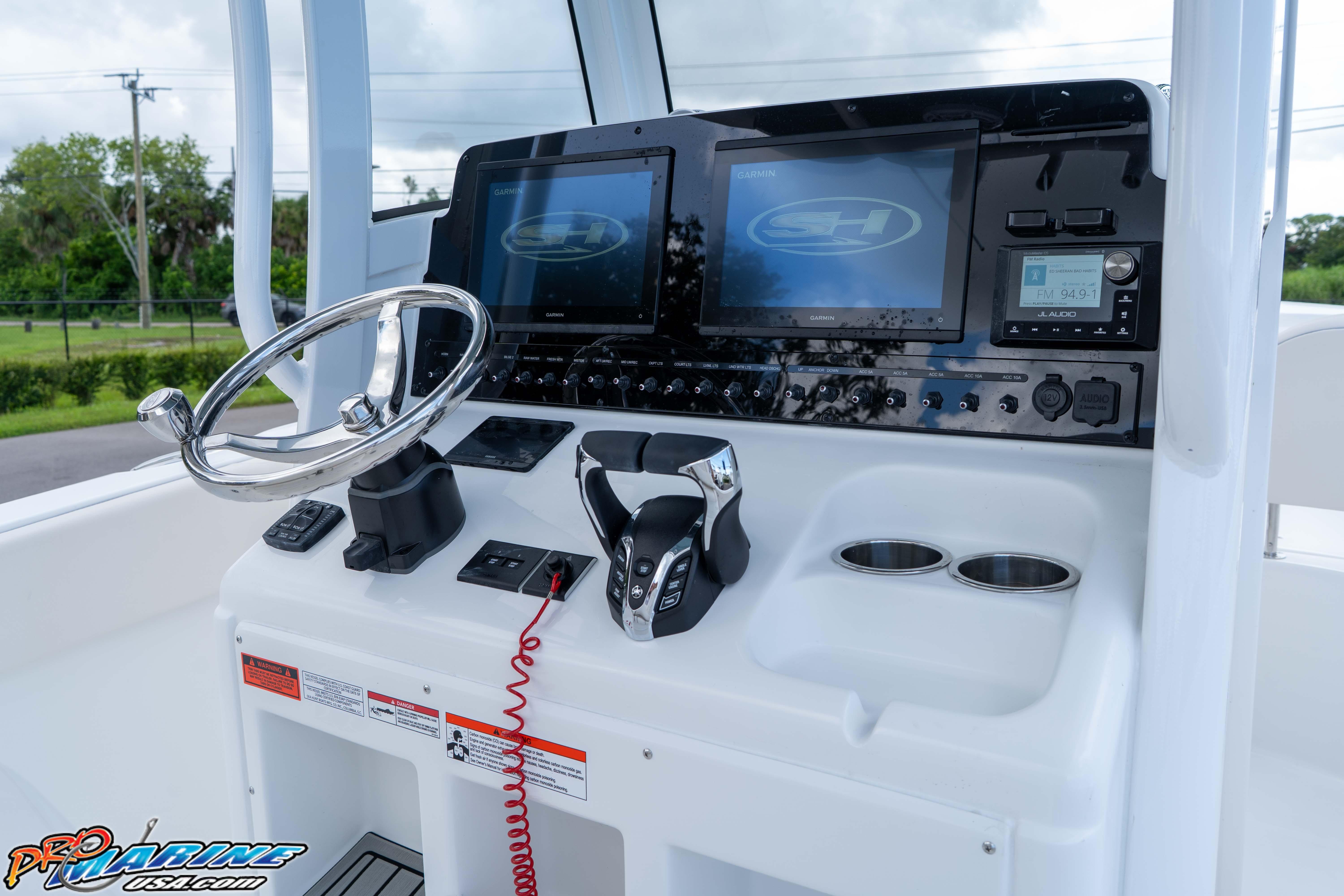 2026 Sea Hunt Ultra 265 SE boat dashboard with steering wheel and electronic controls.