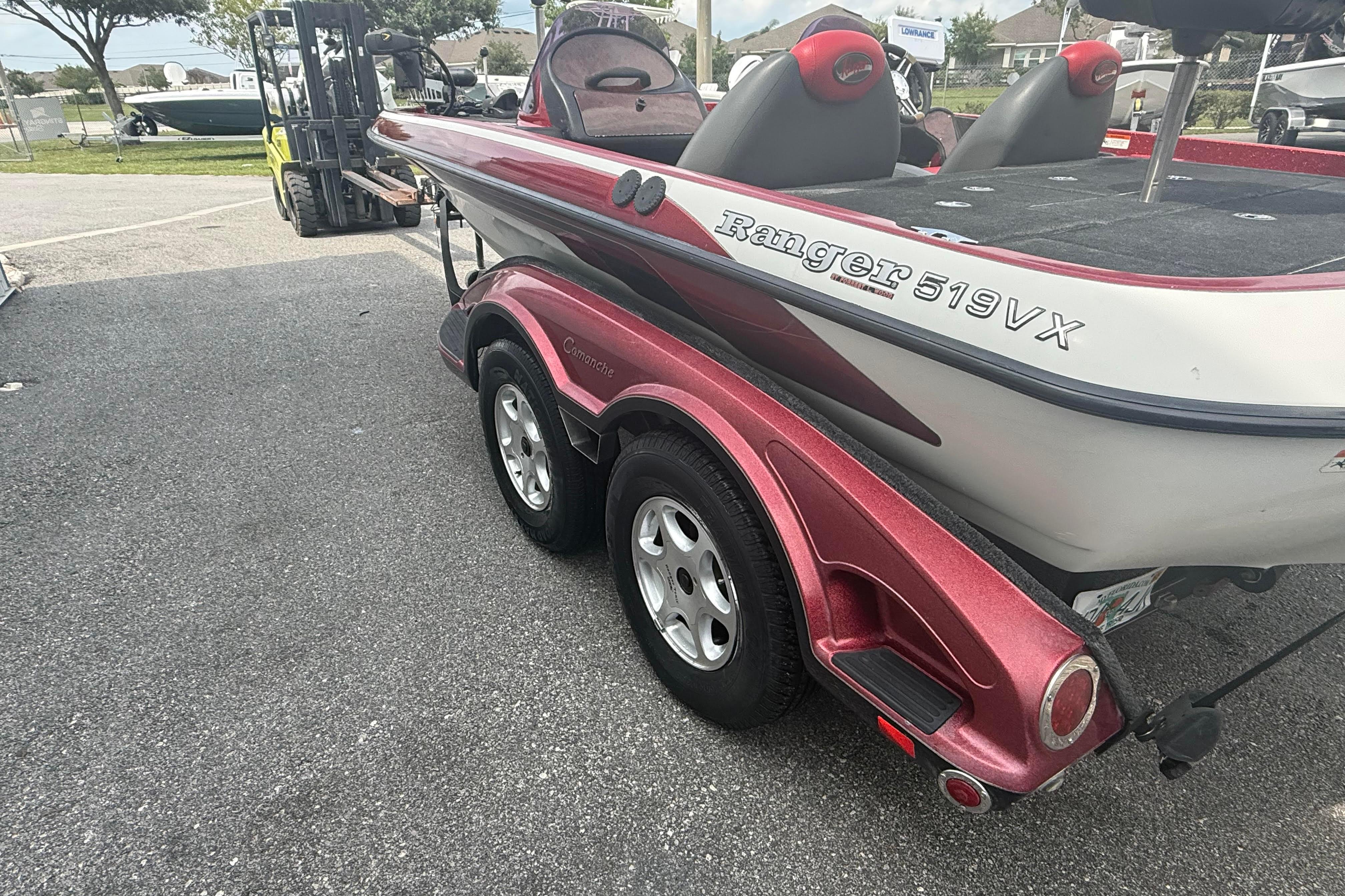 2007 Ranger 519 VX boat on trailer, red and white, parked outdoors.