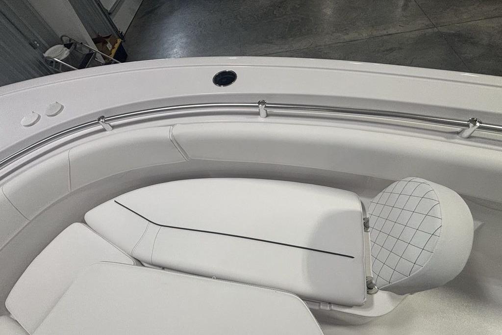 2026 Sportsman Open 252 Center Console boat interior with white cushioned seating.