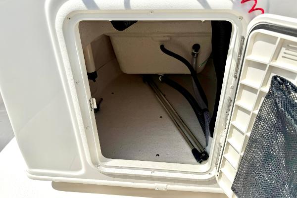 Storage compartment of 2025 Carolina Skiff 21 LS boat, showing interior space and wiring.