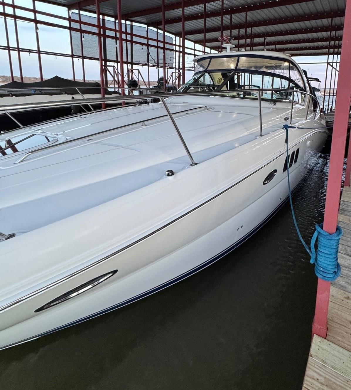 2007 Sea Ray 38 Sundancer yacht docked in a covered marina.