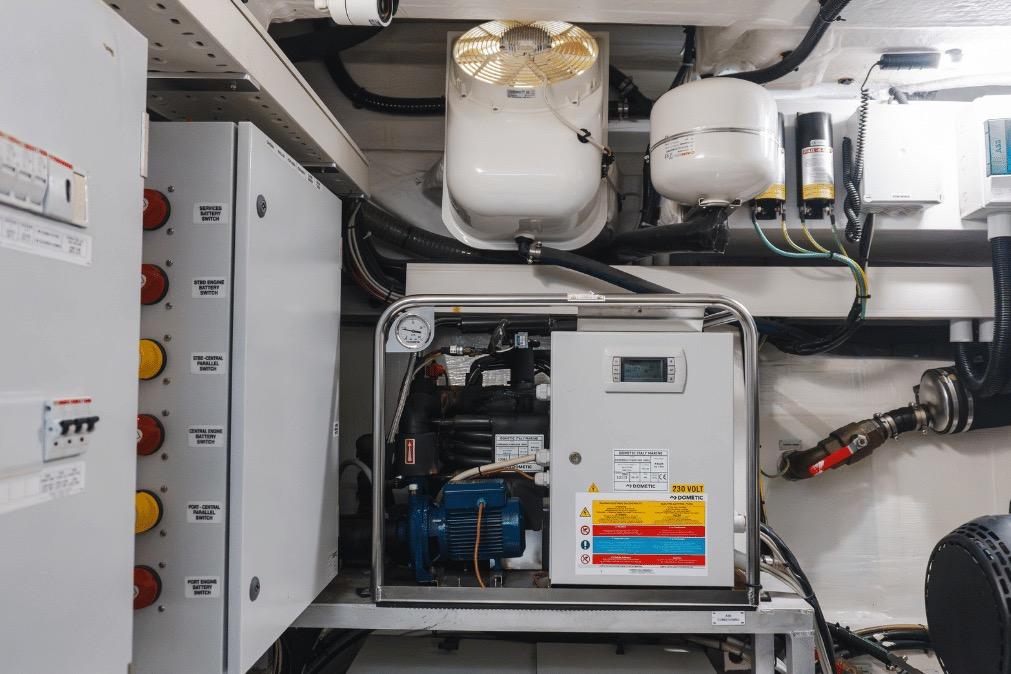 Engine room of a 2020 Azimut 60 yacht, featuring electrical panels and machinery.