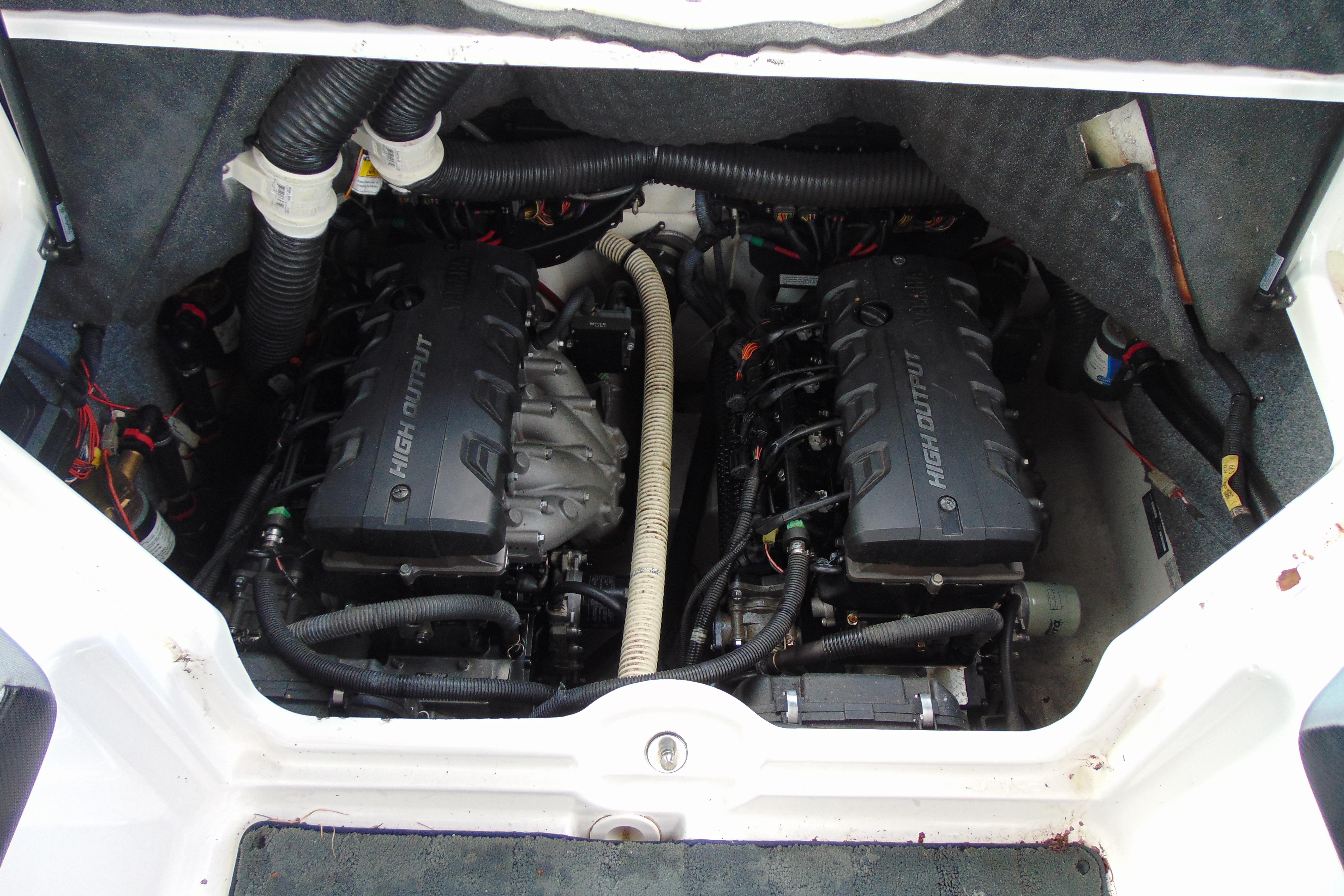 Engine compartment of 2016 Yamaha Boats 242X E-Series, showcasing dual high-output engines.