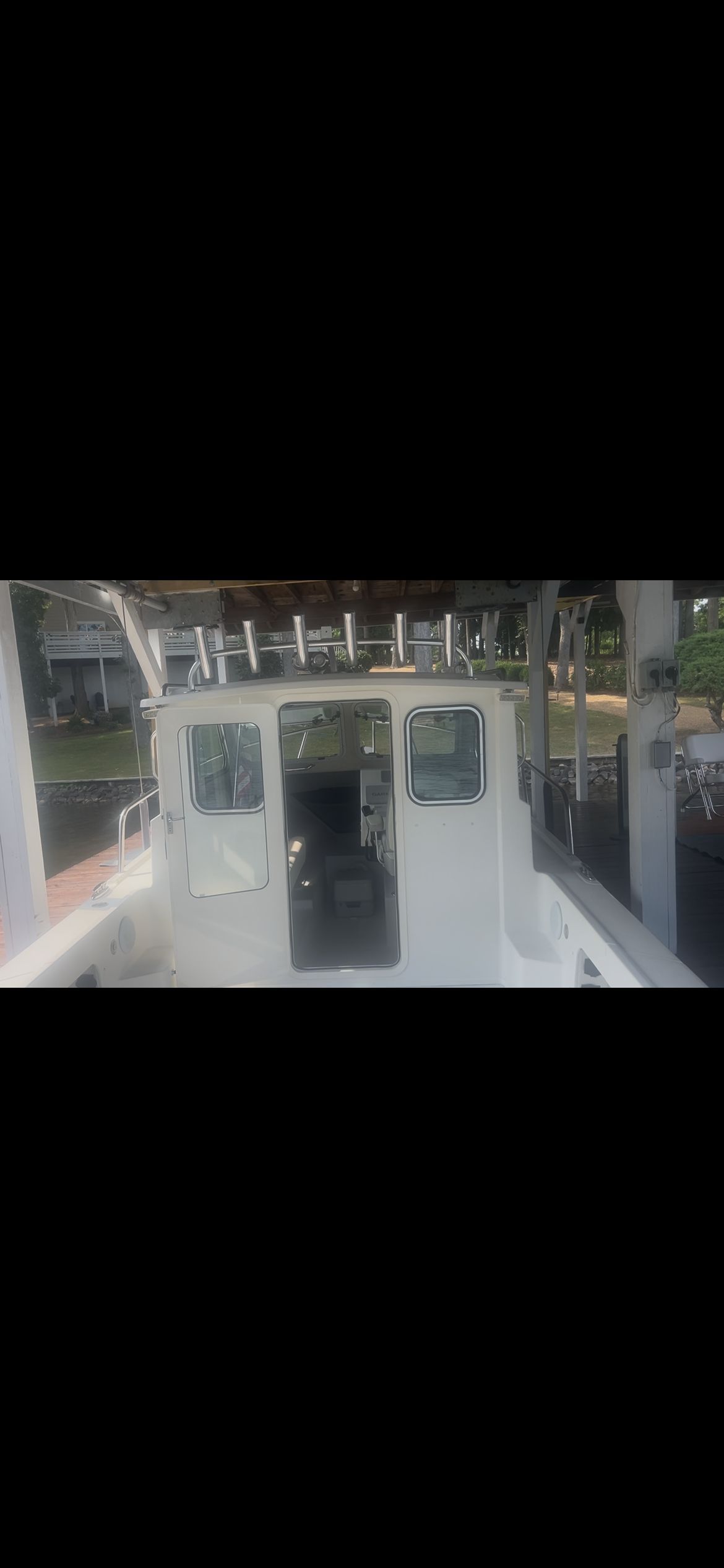 A Parker 2320 Sport Cabin boat docked at a pier.