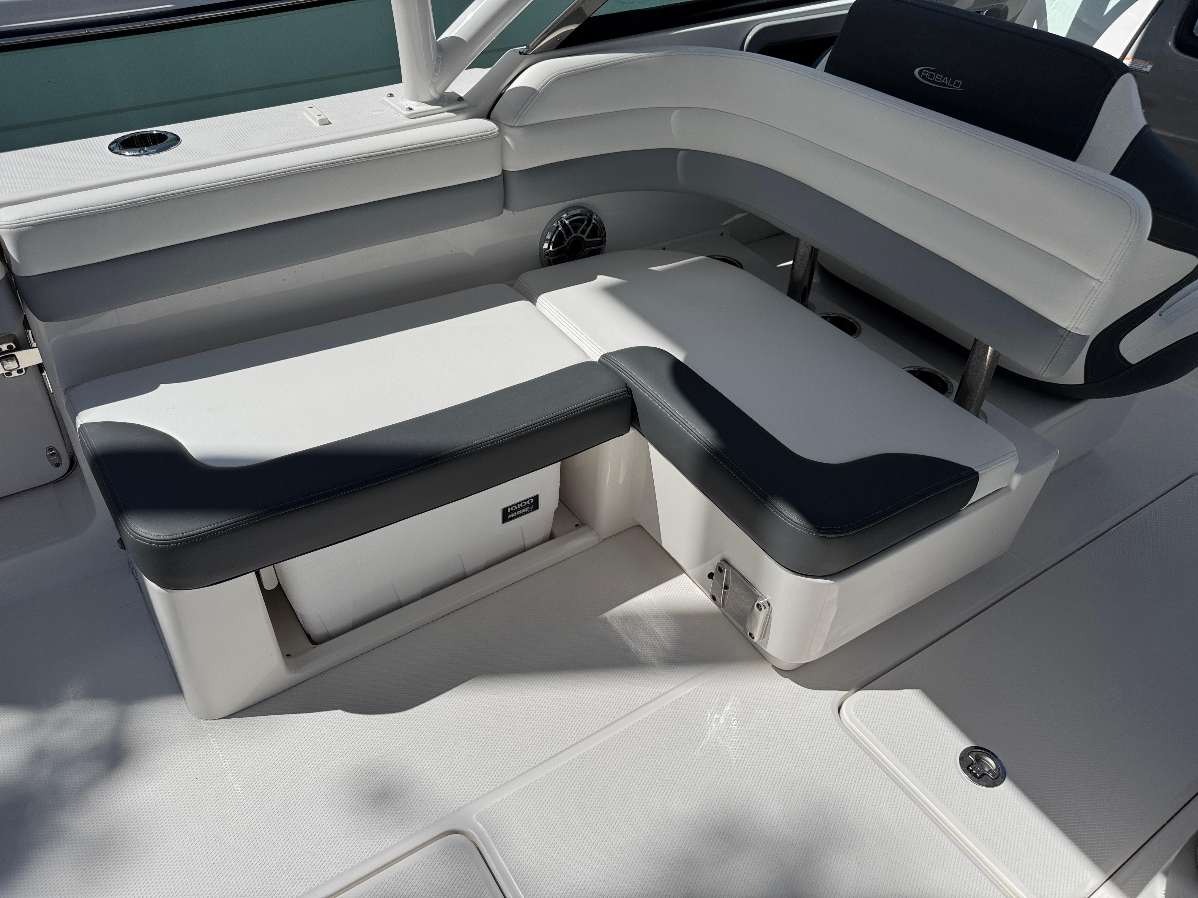 2024 Robalo R317 boat seating area with white and black cushioned seats.