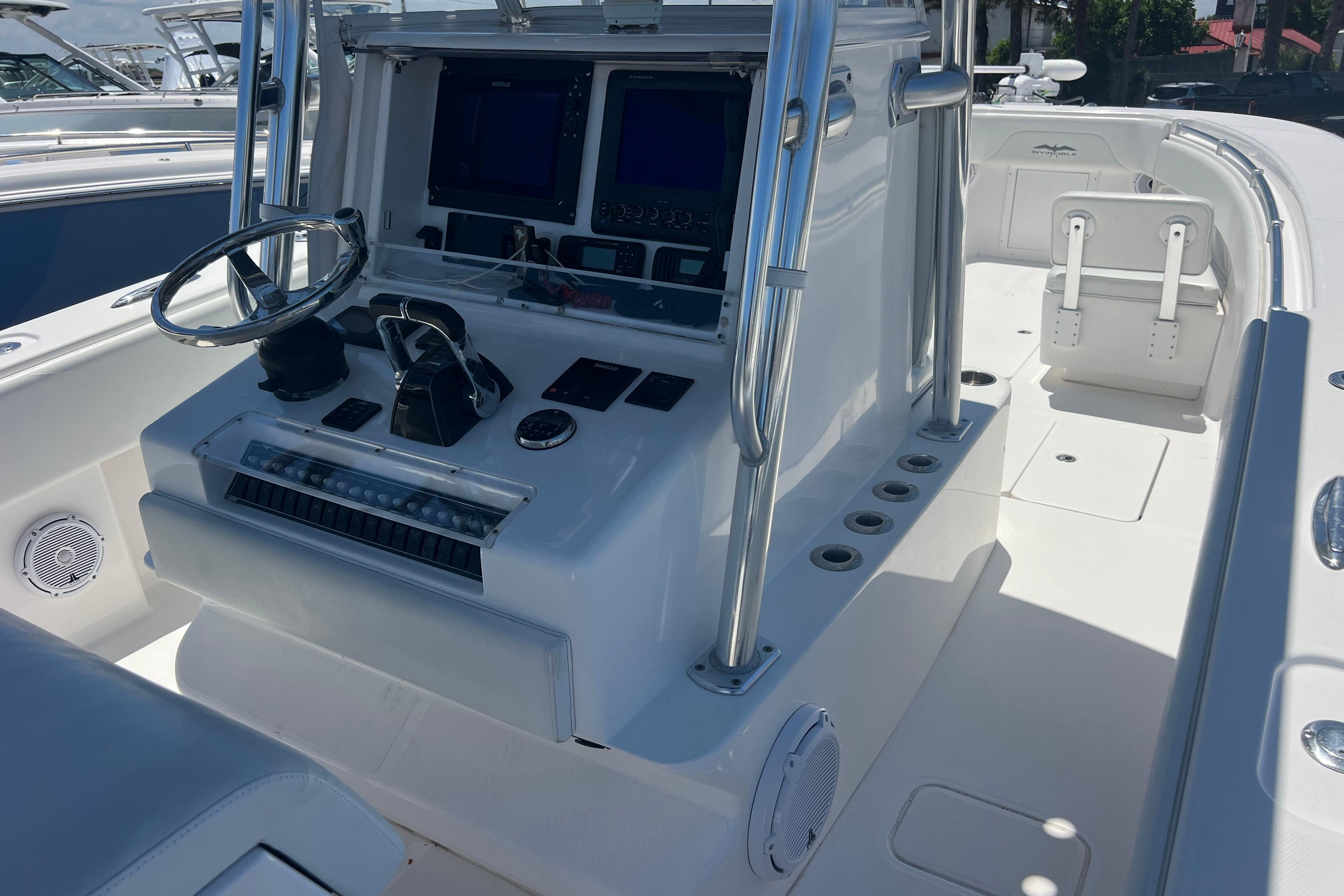 2012 Invincible 33 Open Fisherman boat console with steering wheel and navigation screens.