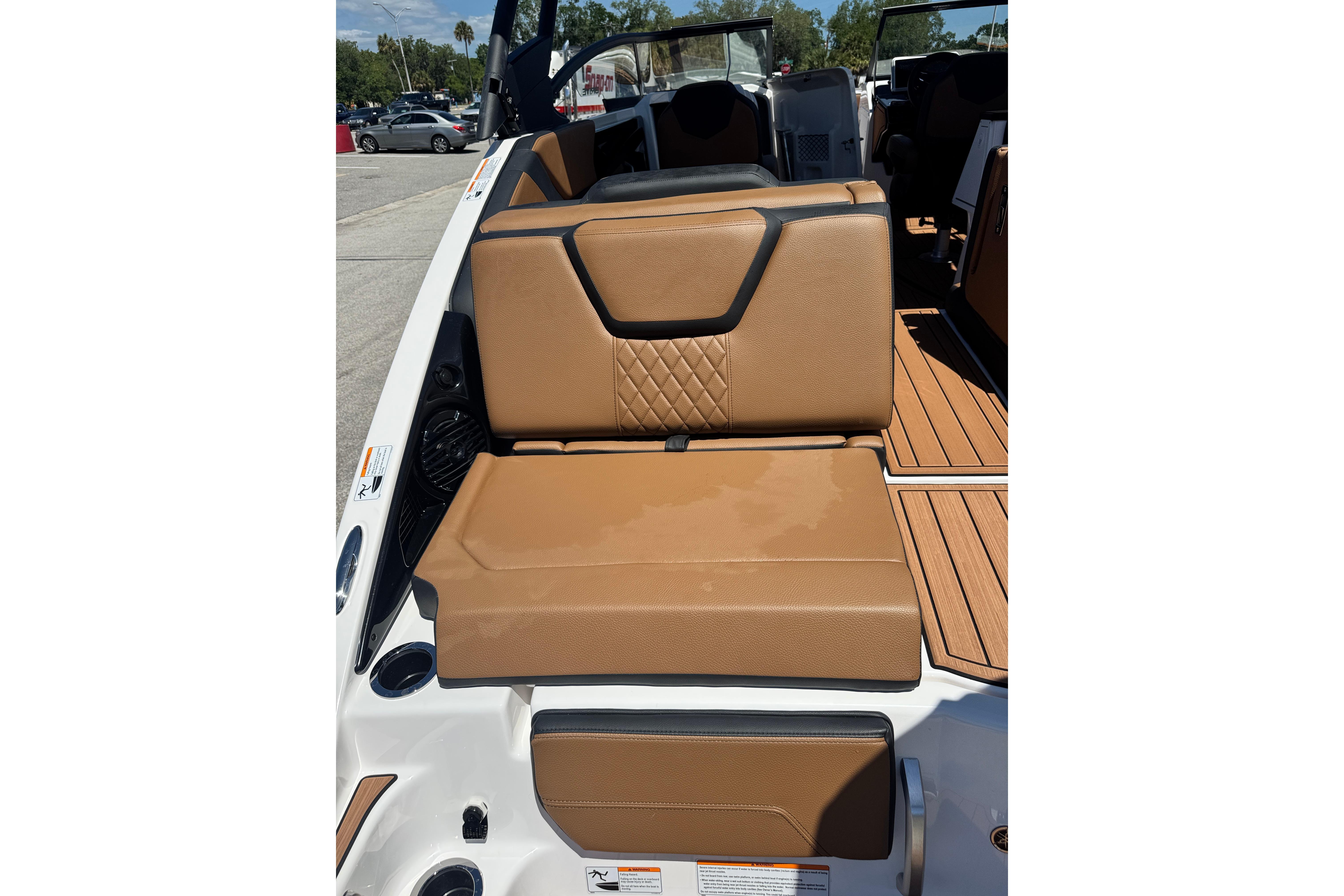 2026 Yamaha Boats 252SD interior with tan leather seating and wood accents.