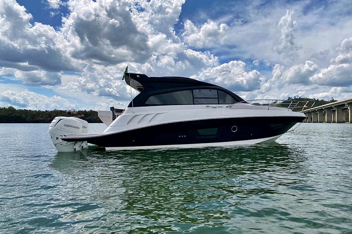 Luxury Hanover 355 boat on water, 2026 model, under a partly cloudy sky.