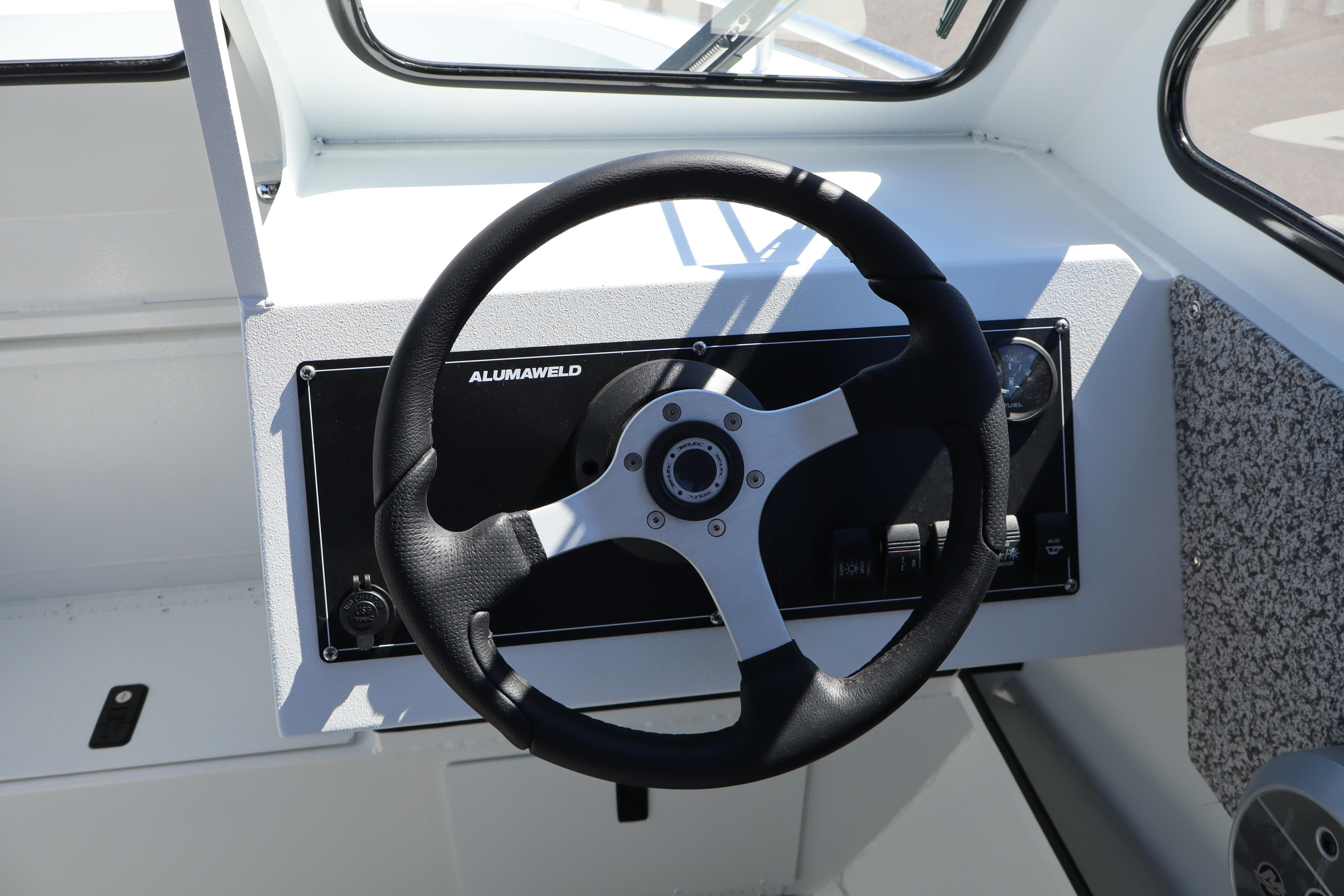 Steering wheel of 2026 Alumaweld Stryker 202 boat, showcasing modern design and controls.