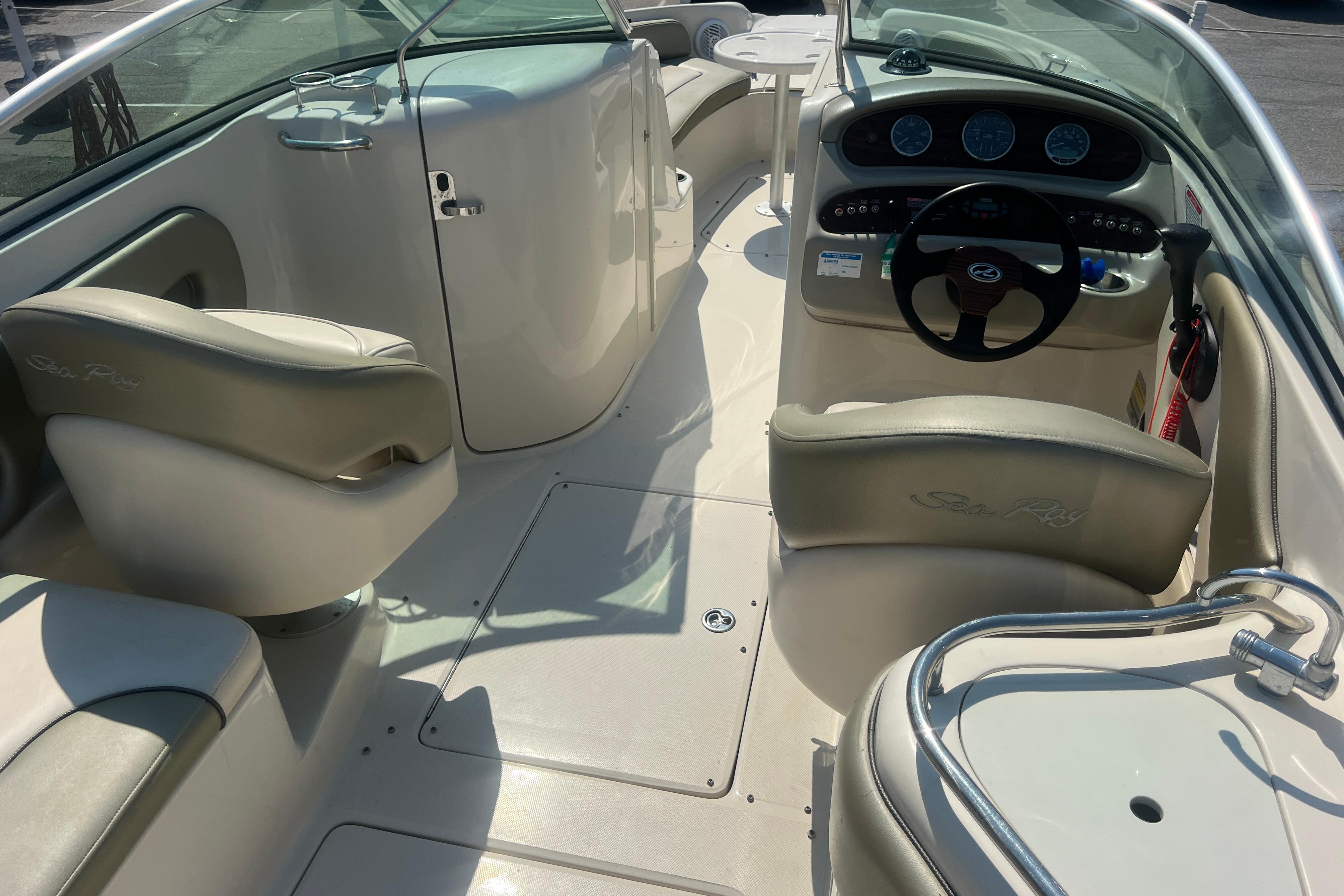 2005 Sea Ray 240 Sundeck interior with steering wheel and seating area.