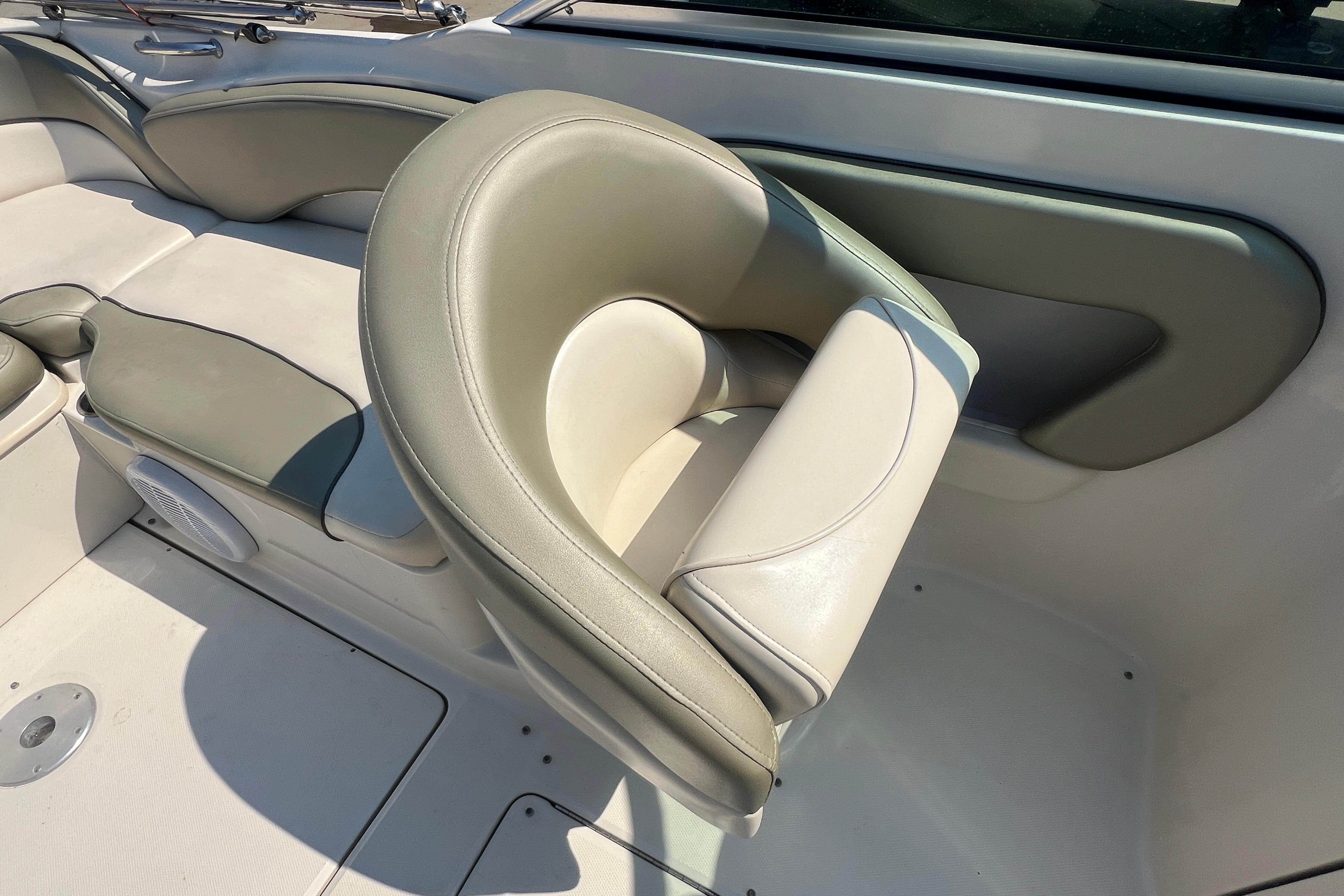 2005 Sea Ray 240 Sundeck interior seating with beige and gray upholstery.