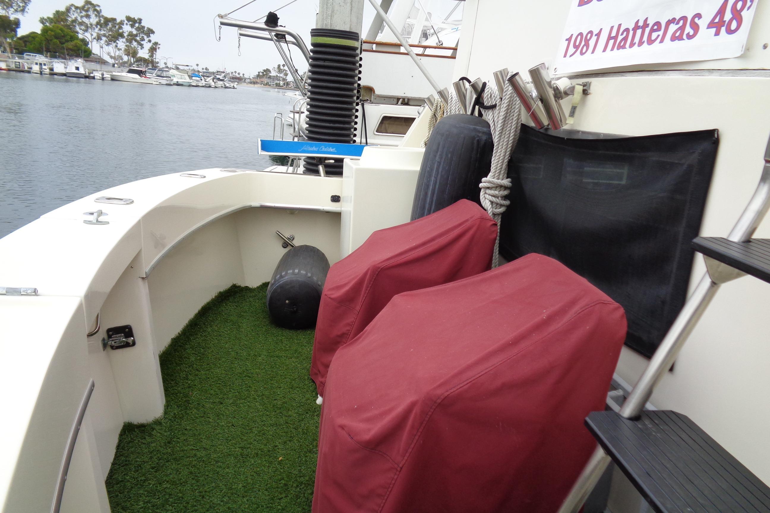 1981 Hatteras 48 Cockpit Motor Yacht with covered seating and marina view.