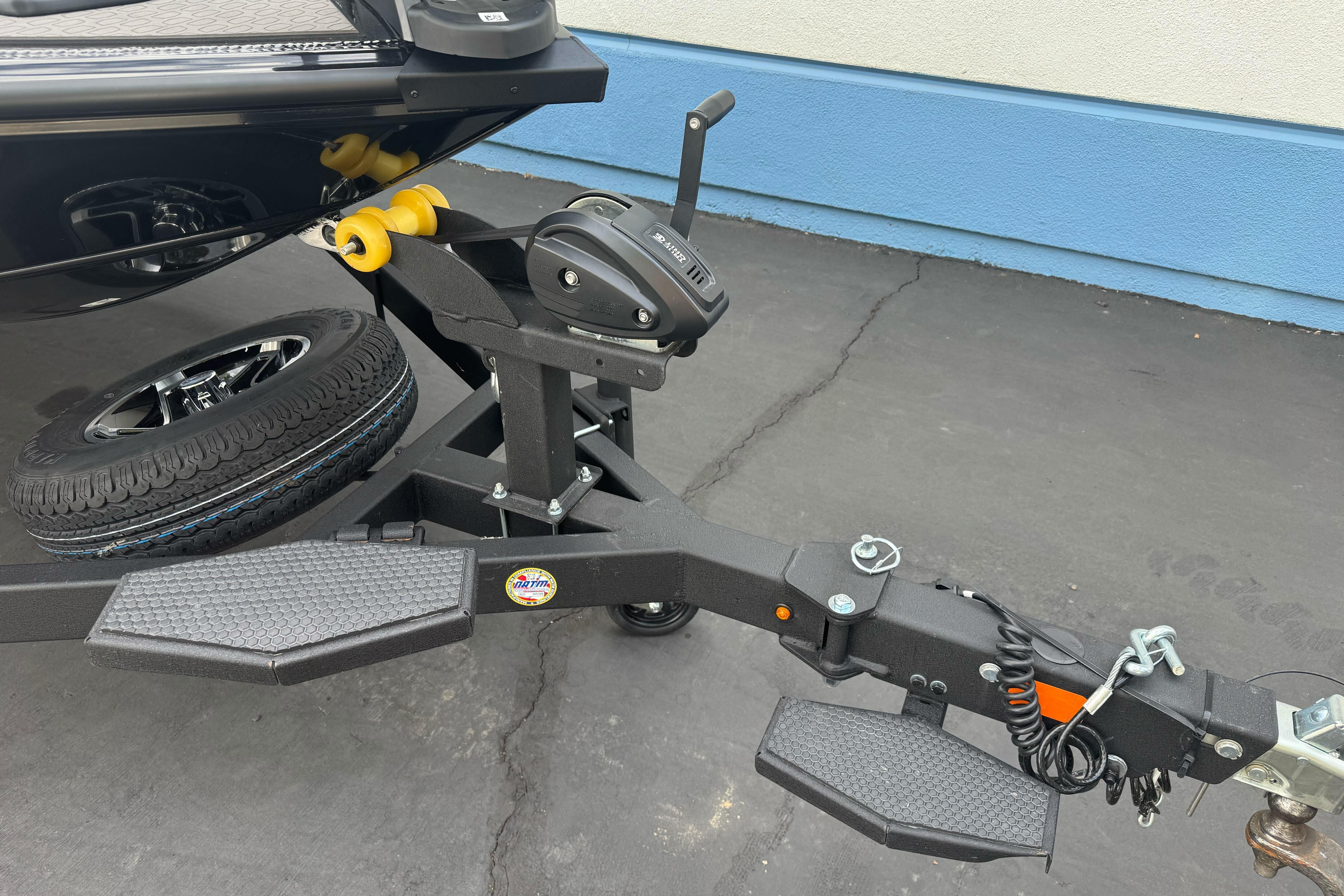 Trailer hitch of a 2026 Ranger ALPHA 208 with spare tire and winch.