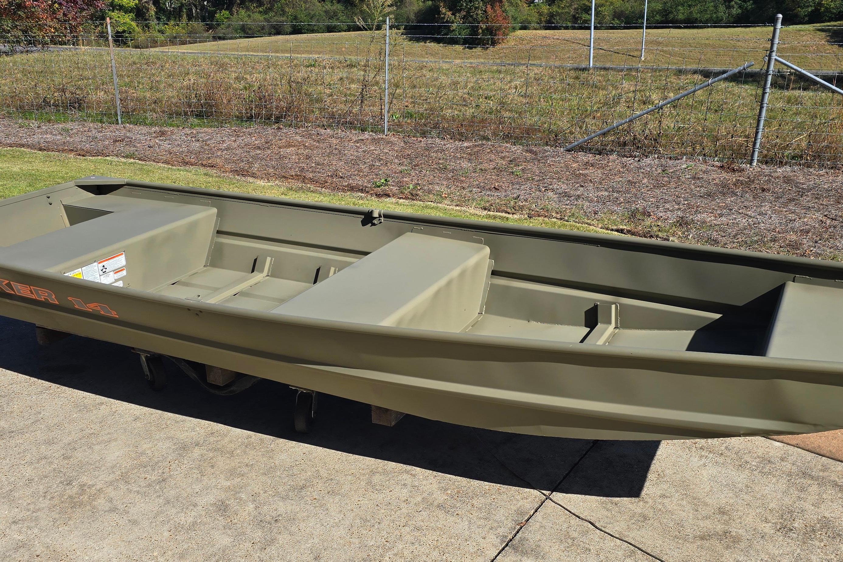 2026 Tracker Grizzly 14 Jon boat on concrete, with grassy background.
