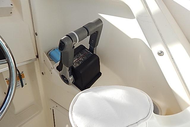 Interior of 2003 World Cat 270 EC boat showing throttle control and white seating.