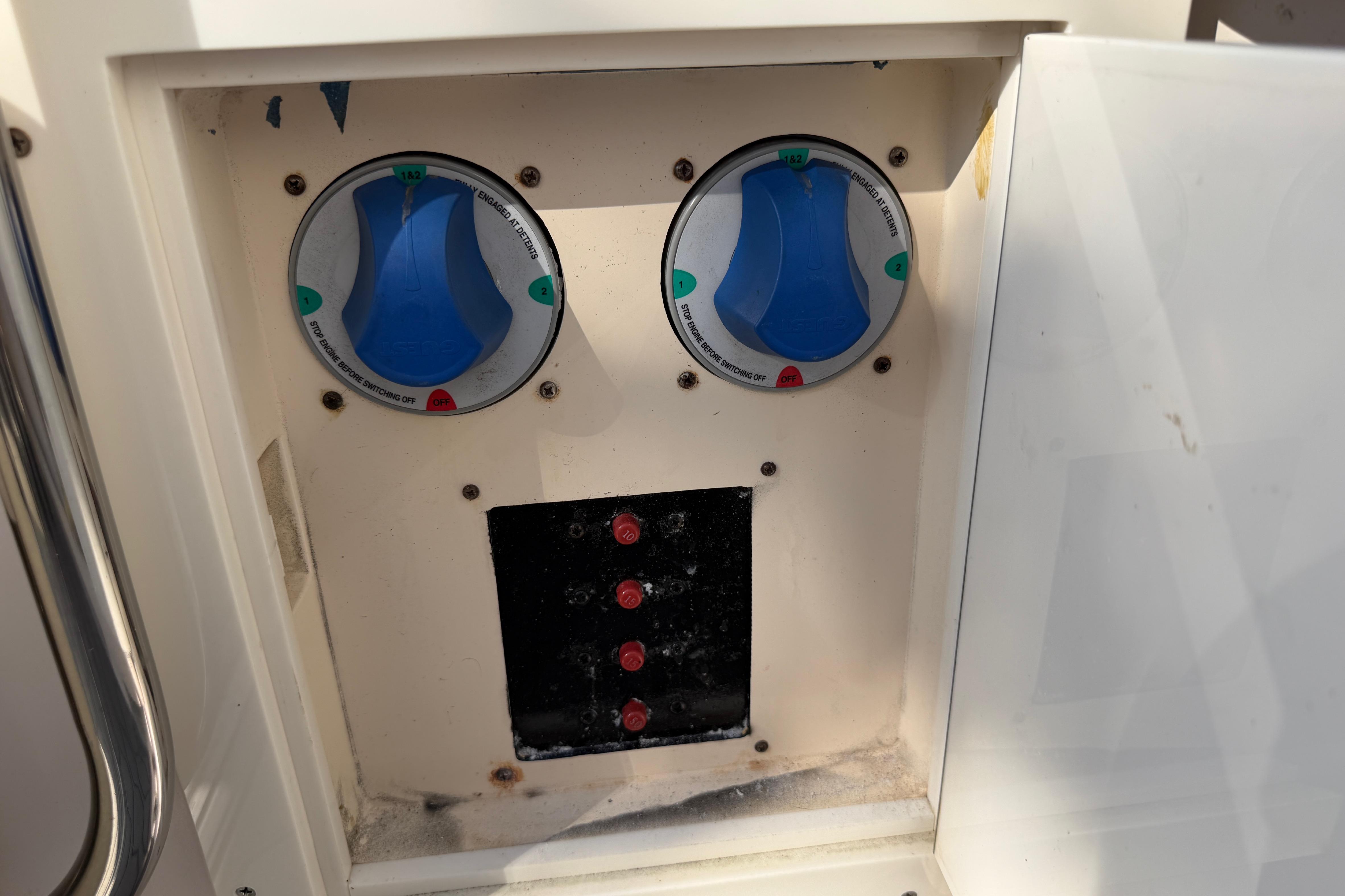 Control panel of a 2004 Grady White 273 boat with switches and dials.