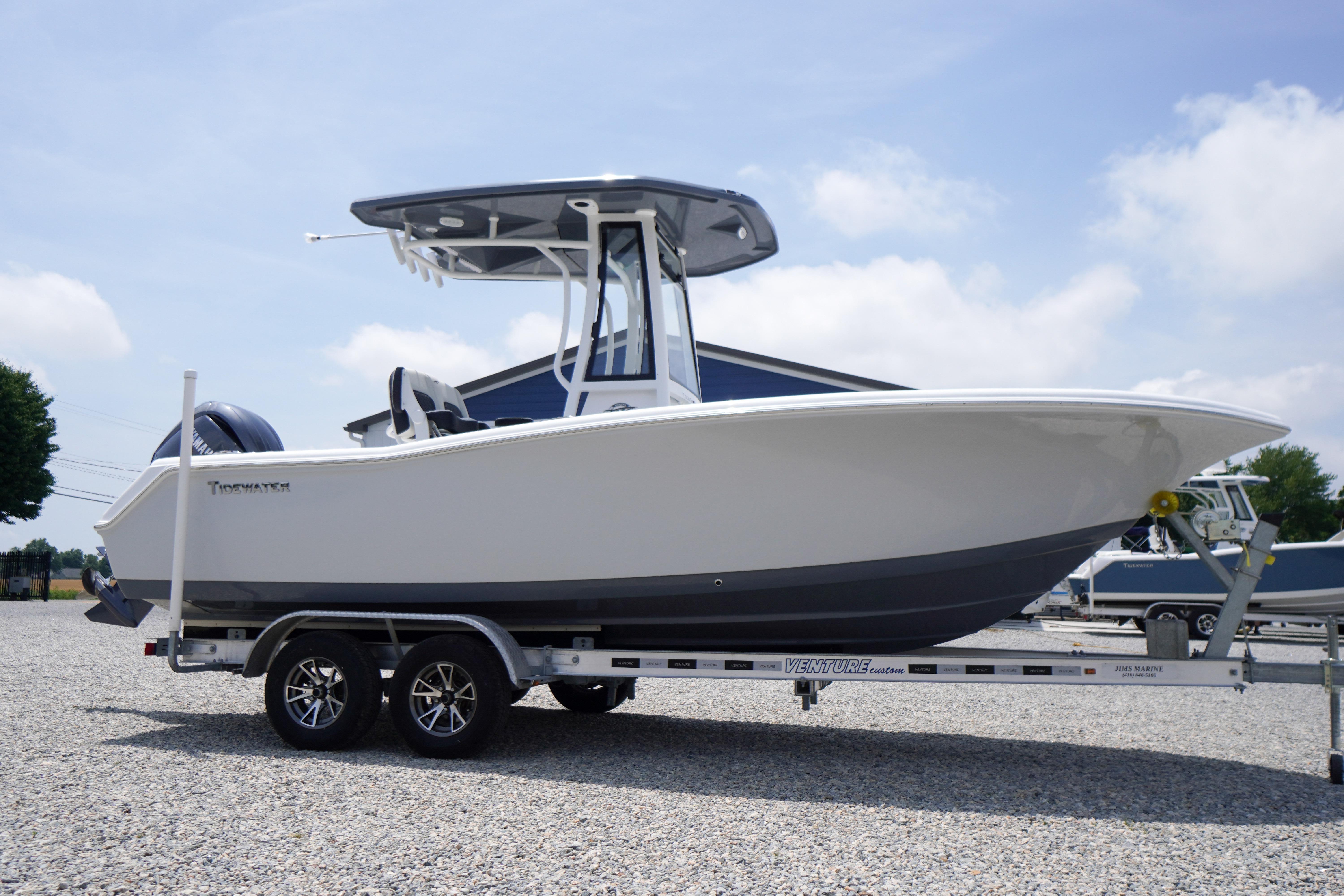 2027 Tidewater 220 CC Adventure boat on trailer, displayed outdoors under clear sky.