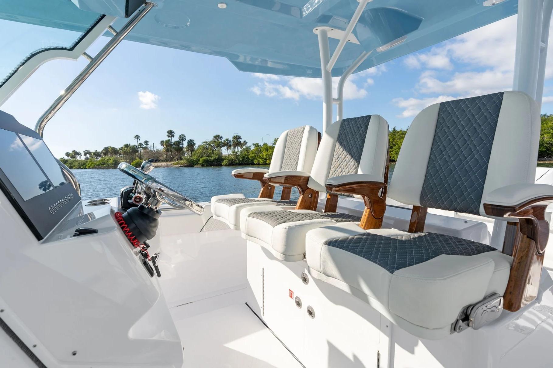 Manufacturer Provided Image: 2026 Bertram 34 CC boat interior with stylish seating and steering wheel.