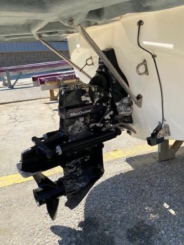 2005 Bayliner 249 SD boat with MerCruiser outdrive, docked on concrete surface.
