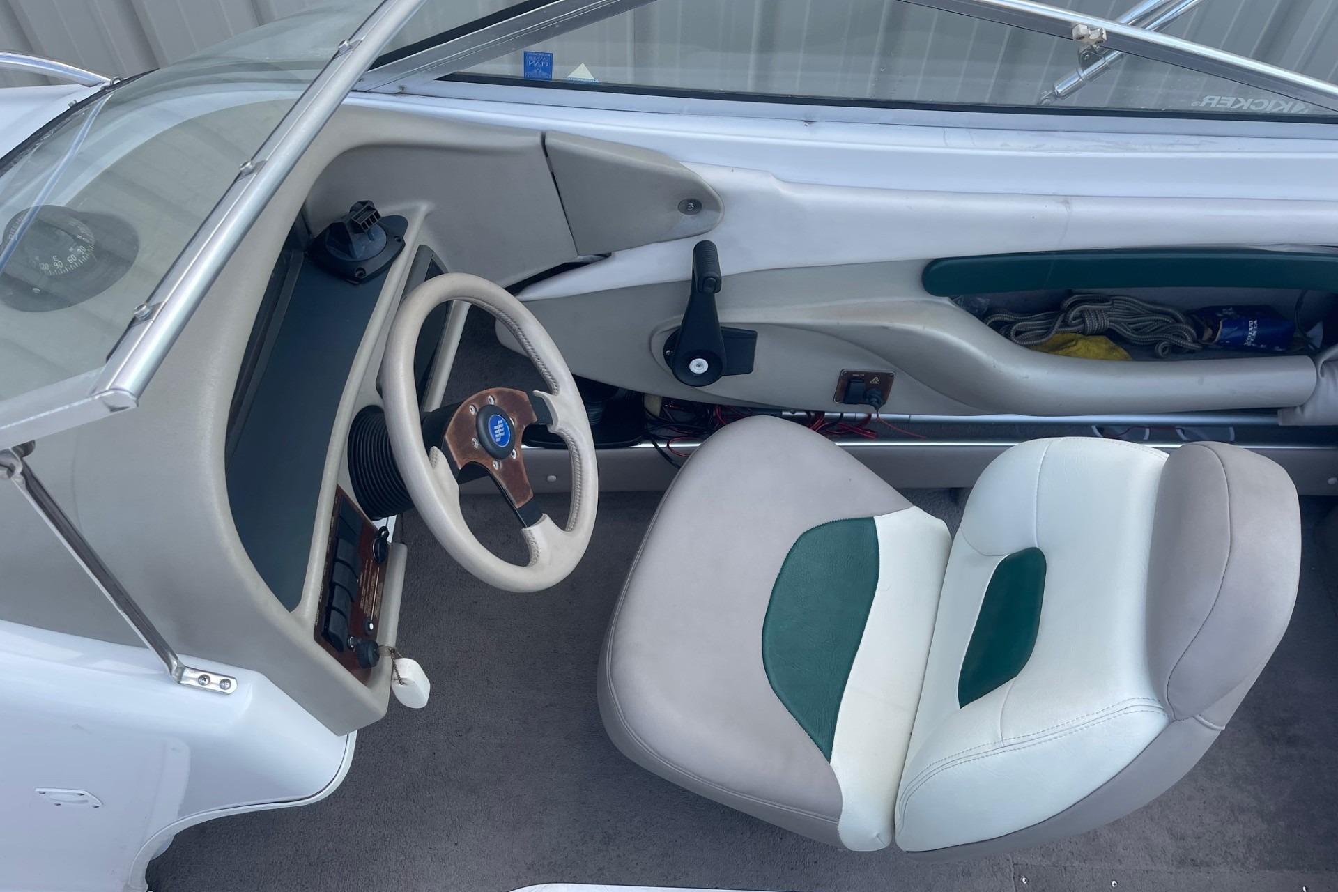 1996 Four Winns 200 Horizon boat interior with steering wheel and seating.