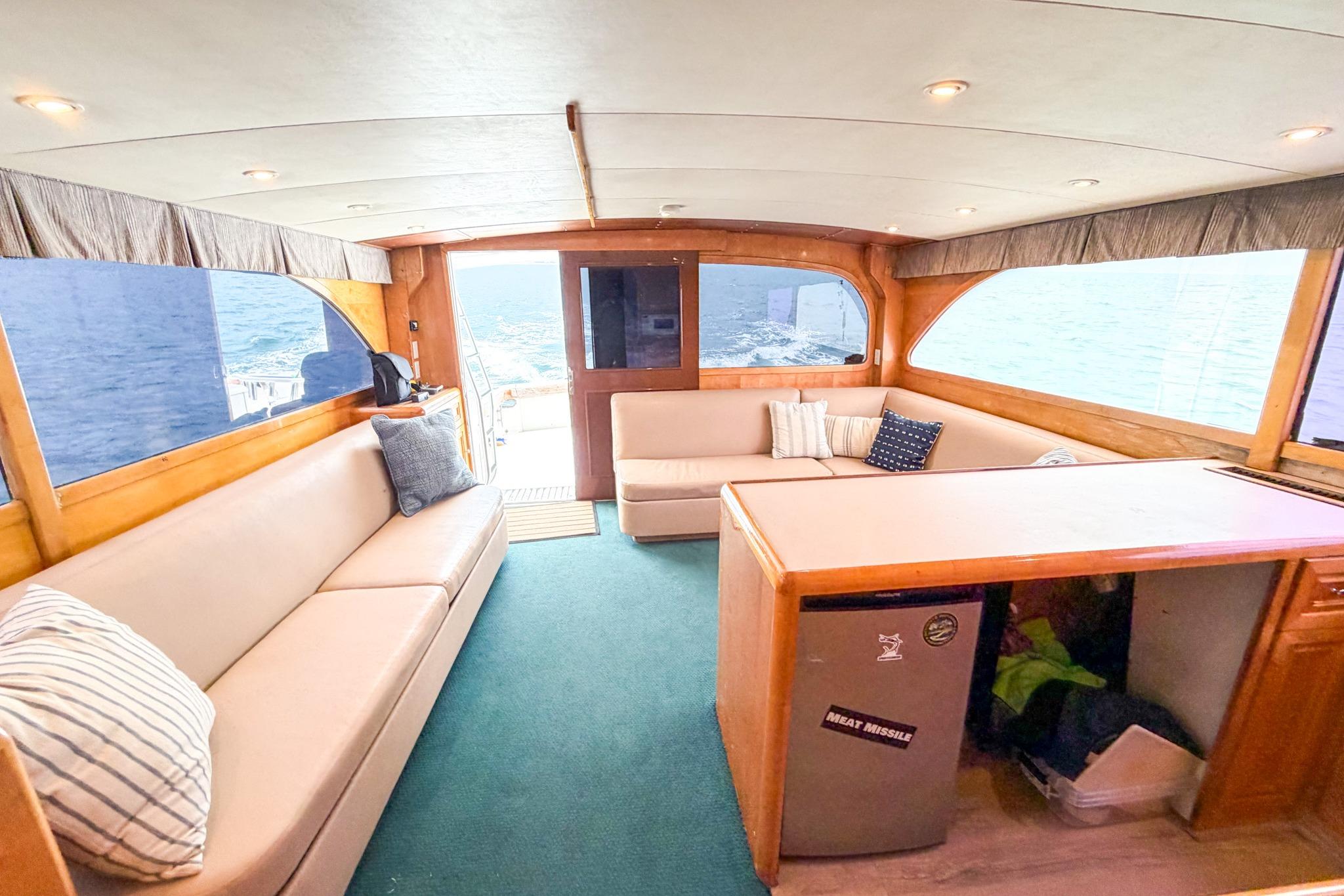 Interior of 1998 Blackwell Custom Carolina Sportfish yacht with cozy seating and ocean view.