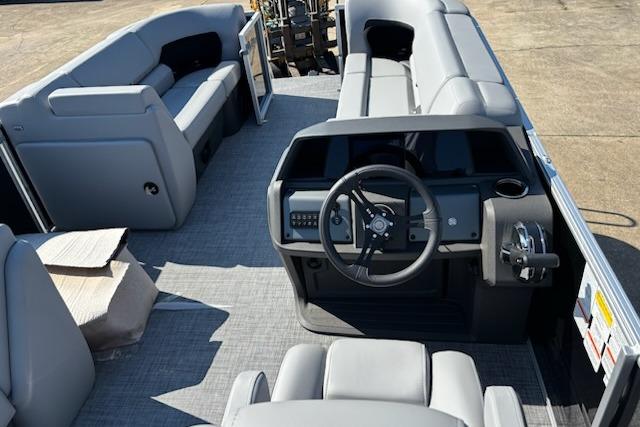 2026 Sun Tracker Party Barge 20 DLX interior with steering console and seating.