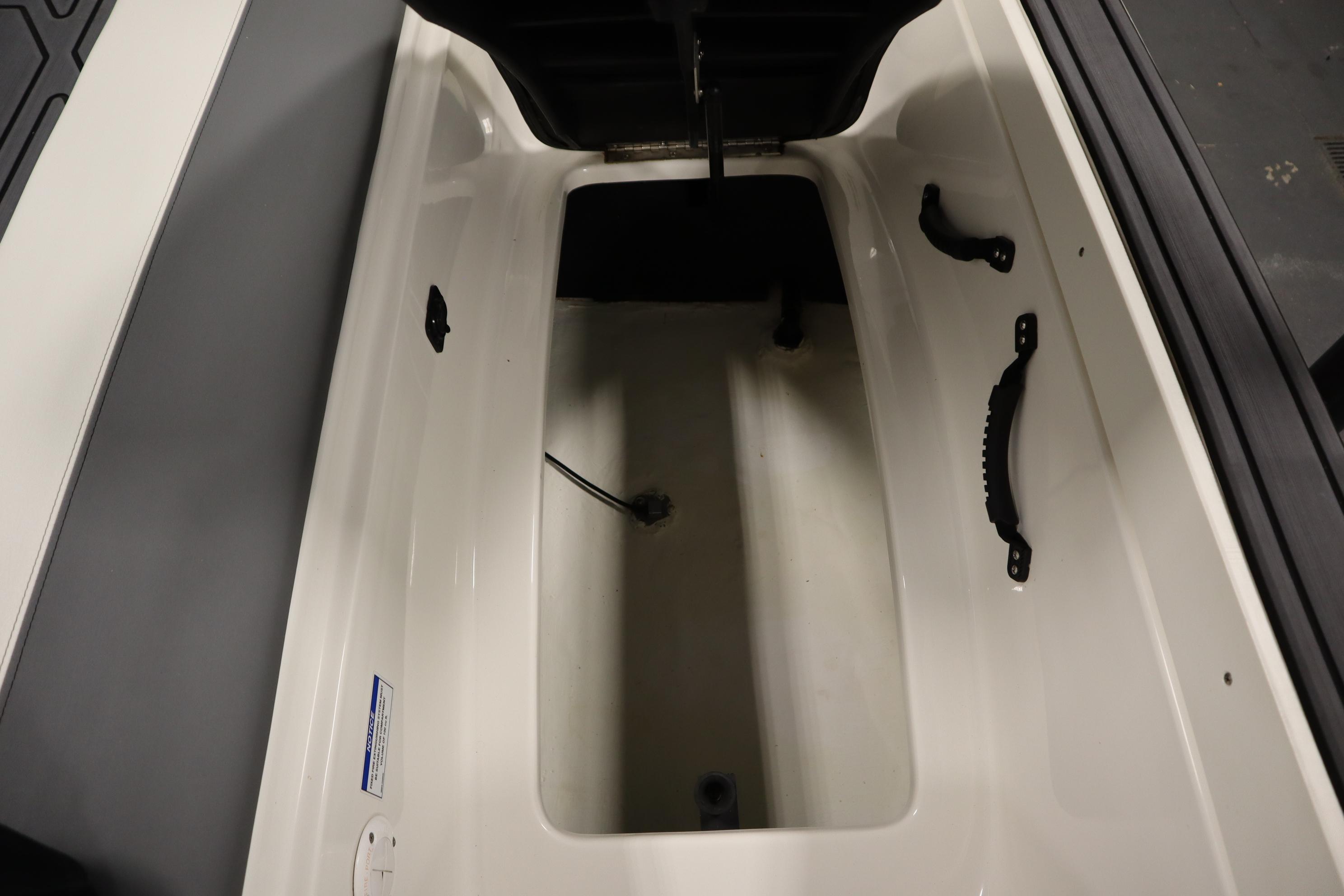 2023 Heyday WT Surf boat interior storage compartment with handles and cable.