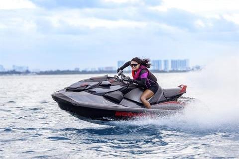 2026 Sea-Doo GTR-X 300 jet ski speeding on open water with city skyline backdrop.