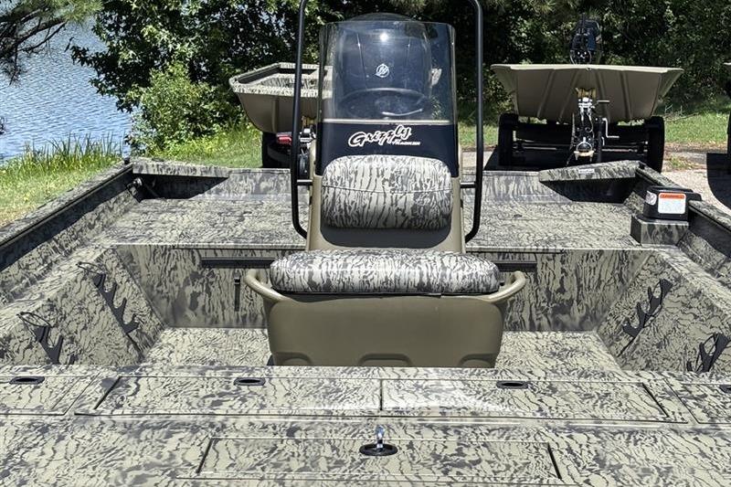 2026 Tracker Grizzly 2072 CC boat with camouflage design near a lake.