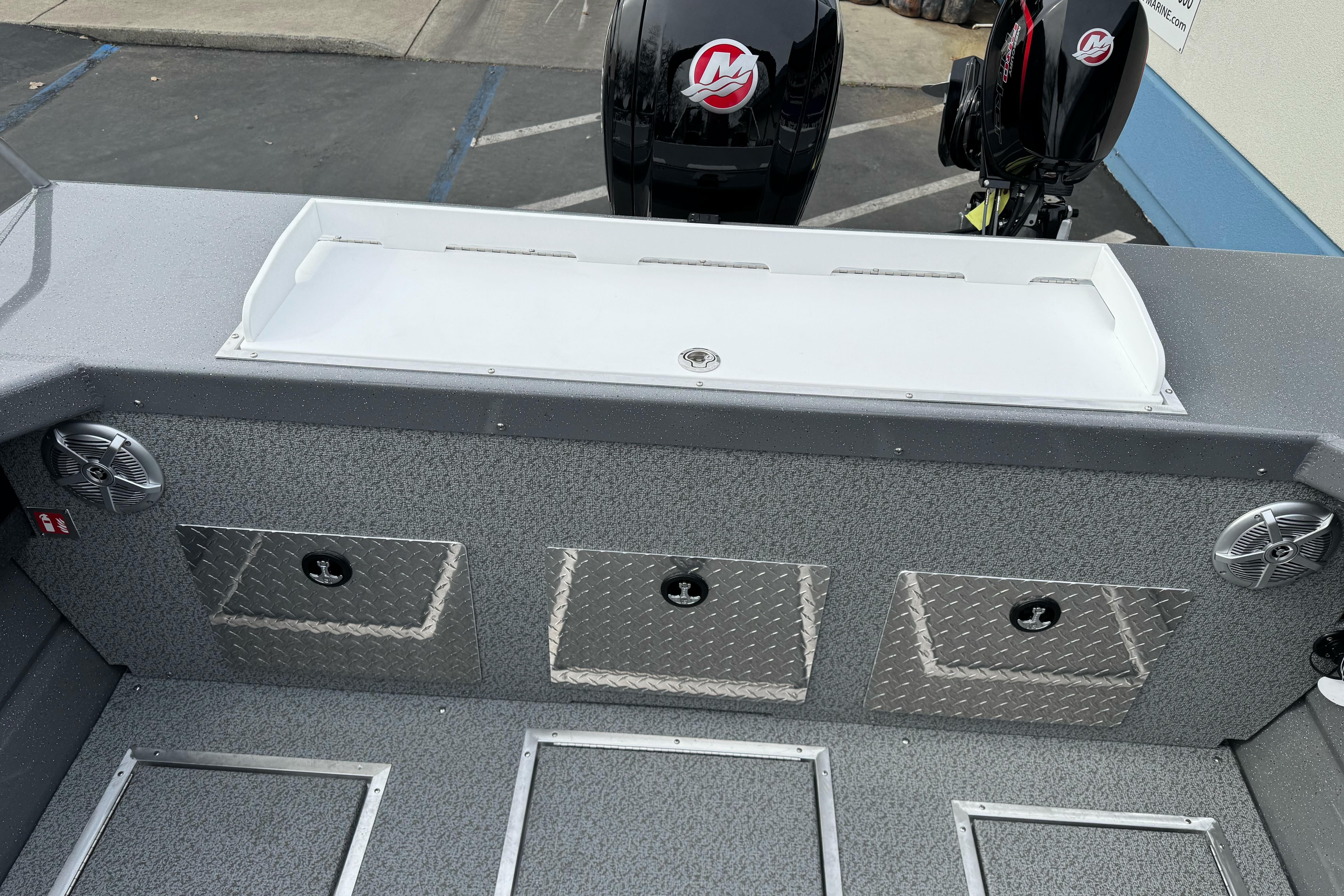 2026 Lund 185 Heavy Gauge boat interior with storage compartments and dual outboard motors.