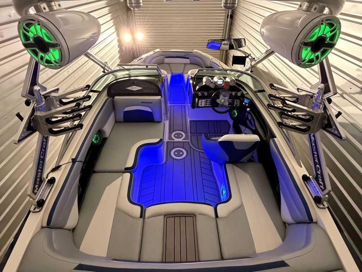 Interior of a 2008 MasterCraft XStar with blue LED lighting and modern speakers.