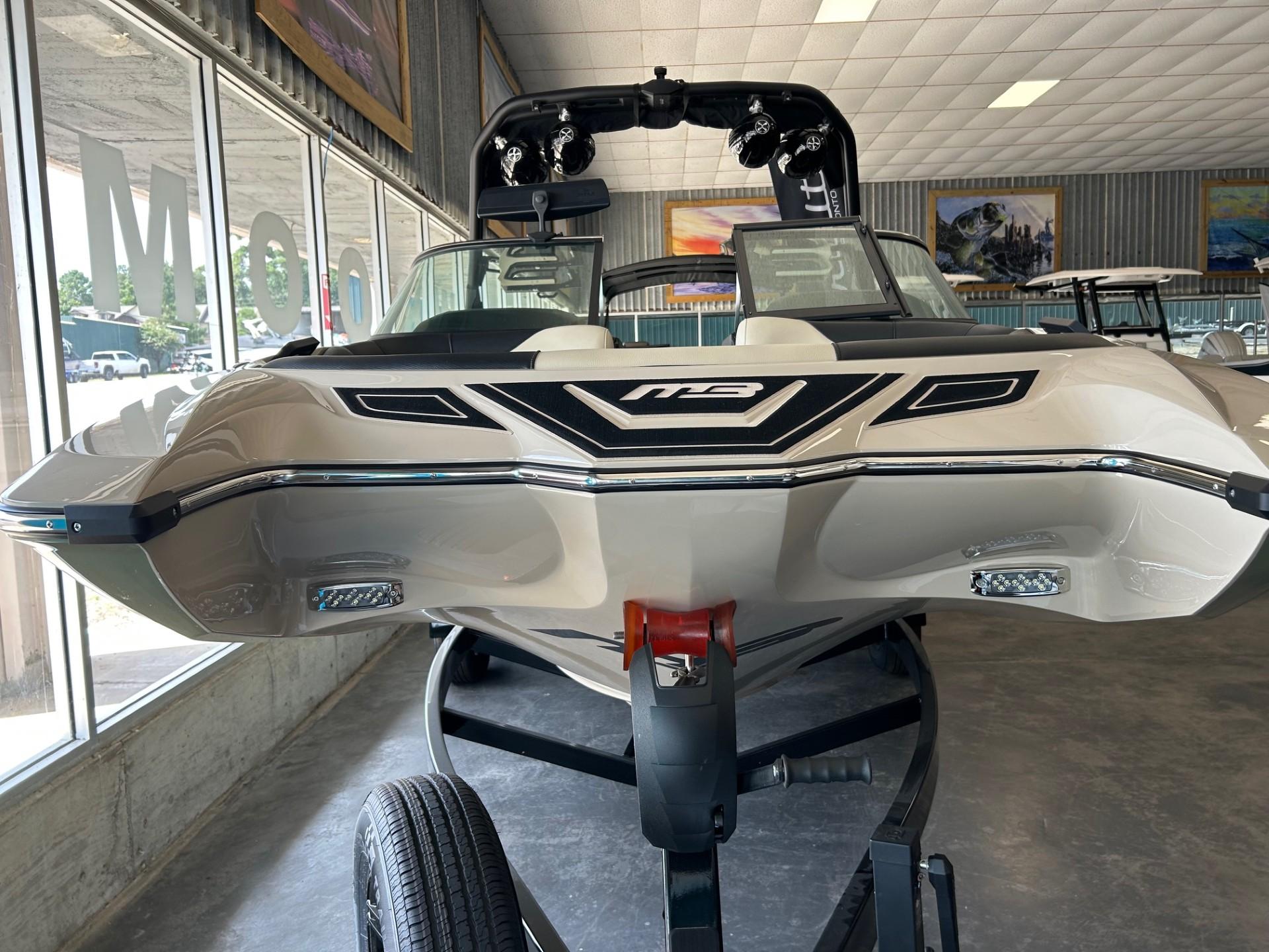 2024 MB F22 Tomcat boat displayed indoors on a trailer.