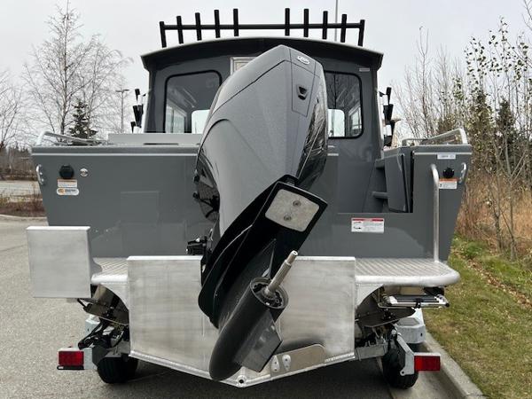 2024 Spartan 220 Maximus boat with powerful outboard motor, parked on a paved surface.