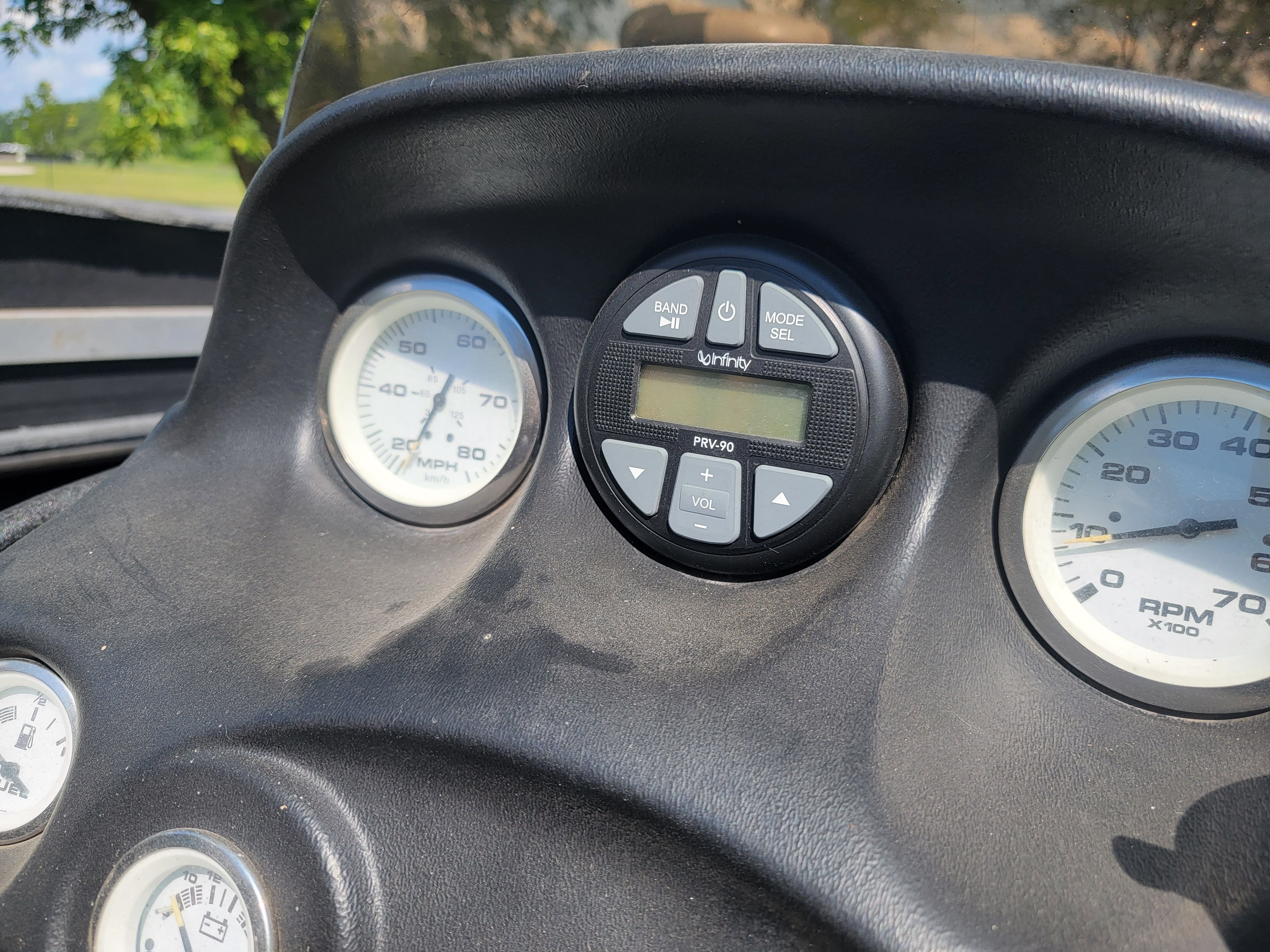 Close-up of a 2004 Nitro NX 882 SC boat dashboard with gauges and a radio.