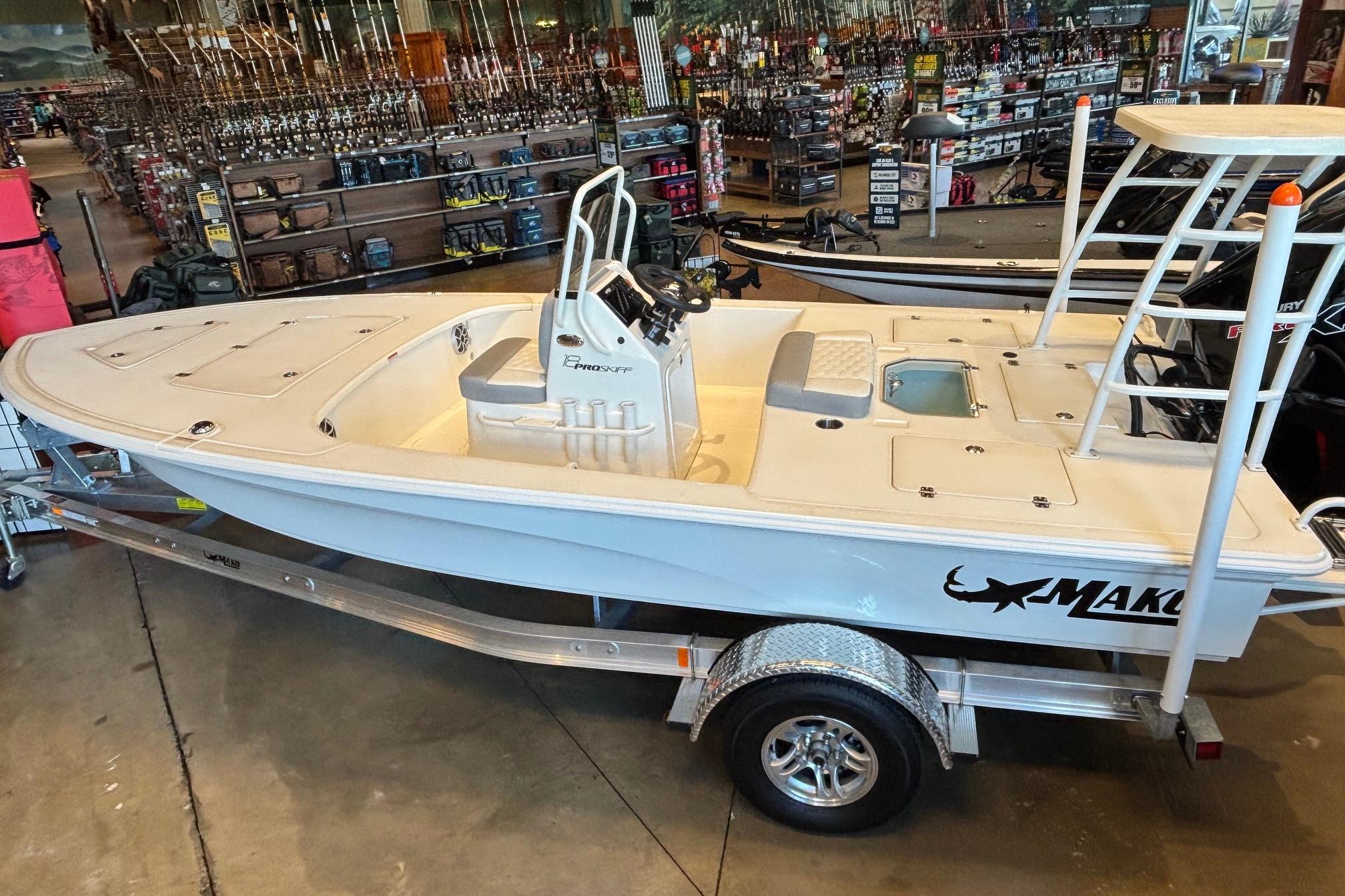 2026 Mako 18 Pro Skiff boat displayed indoors on a trailer.
