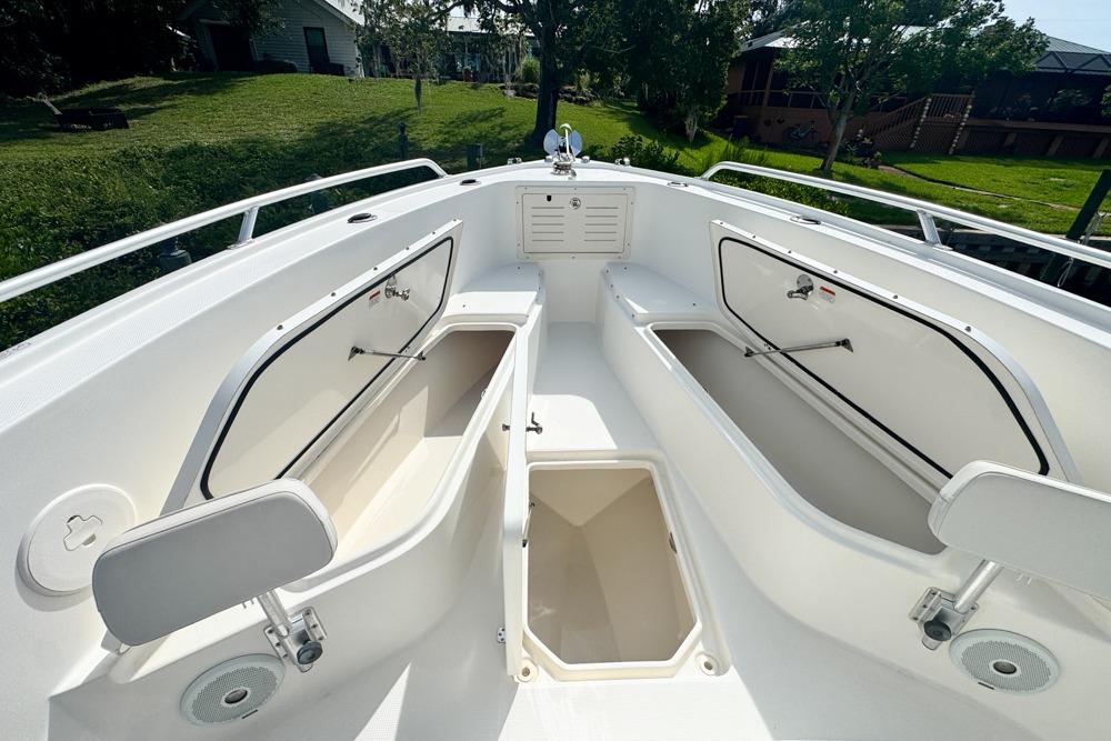 2018 Mako 284 Center Console boat with open storage compartments and sleek design.