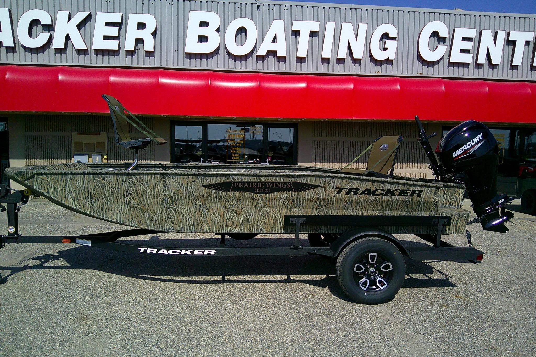 2026 Tracker Grizzly 1650 T Prairie Wings Edition boat at dealership, camo design, Mercury engine.