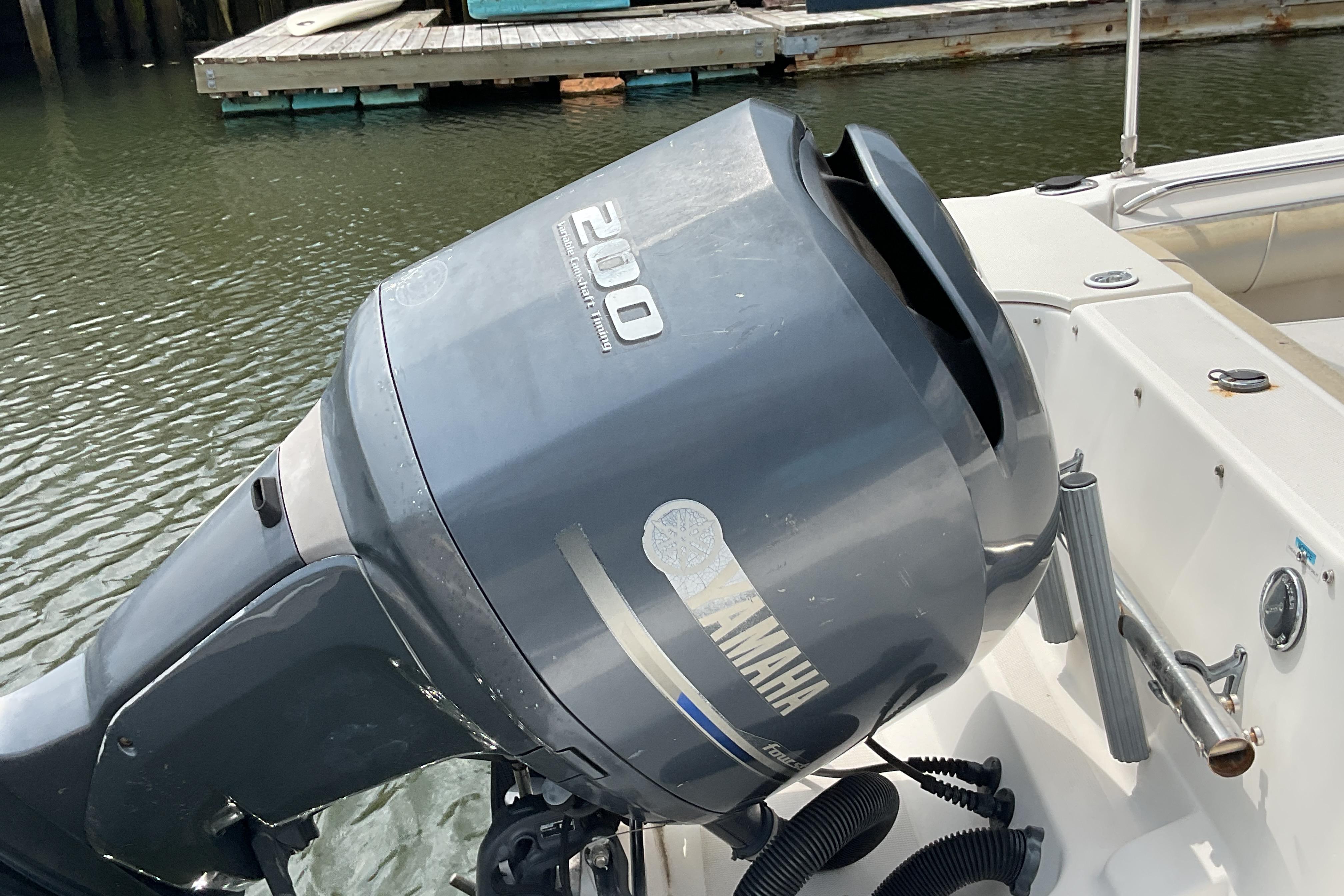Yamaha 200 outboard motor on a 2012 Wellcraft 232 Coastal boat at a dock.