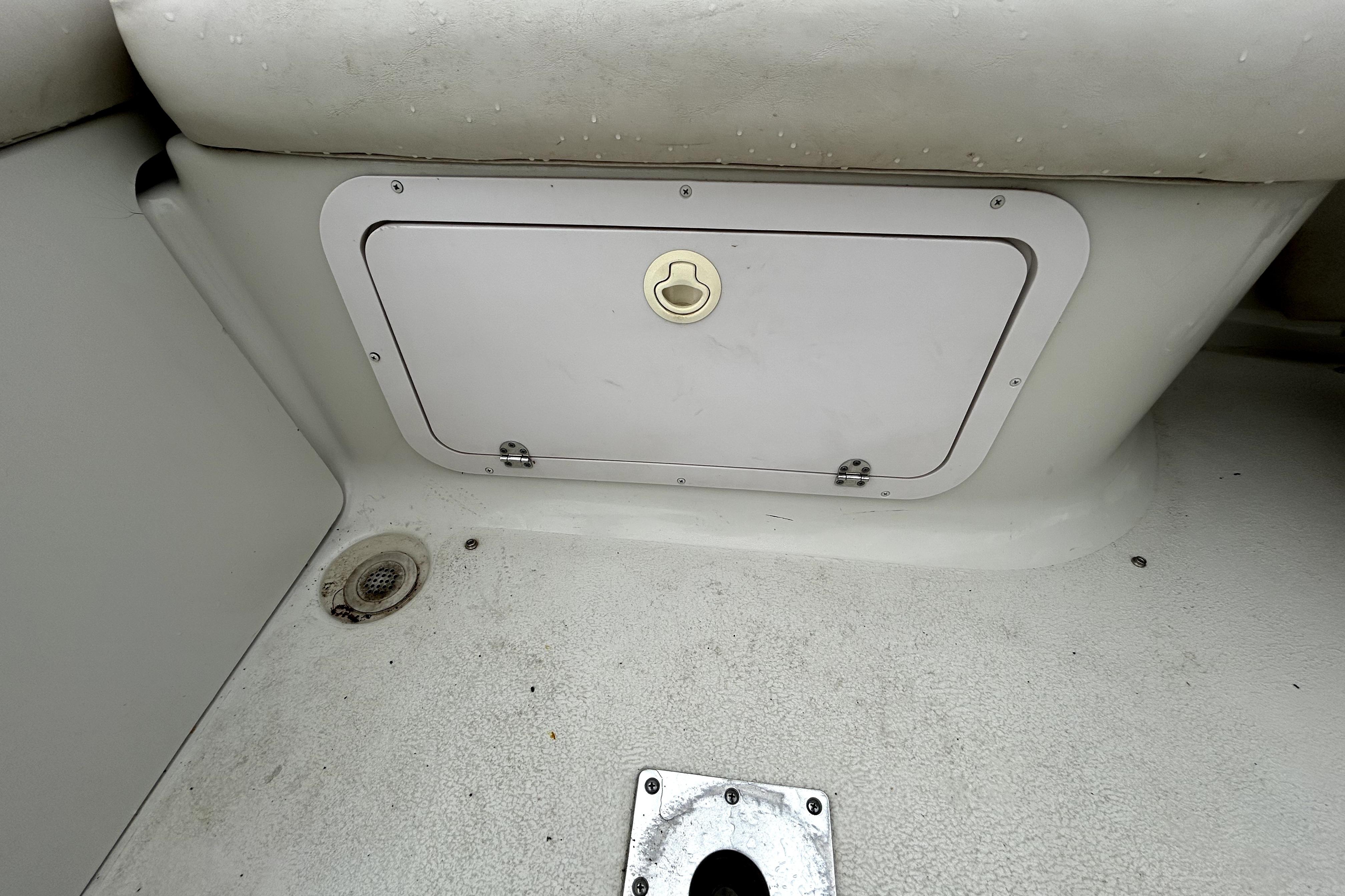 Storage compartment on a 2001 Crownline 239 DB boat interior.