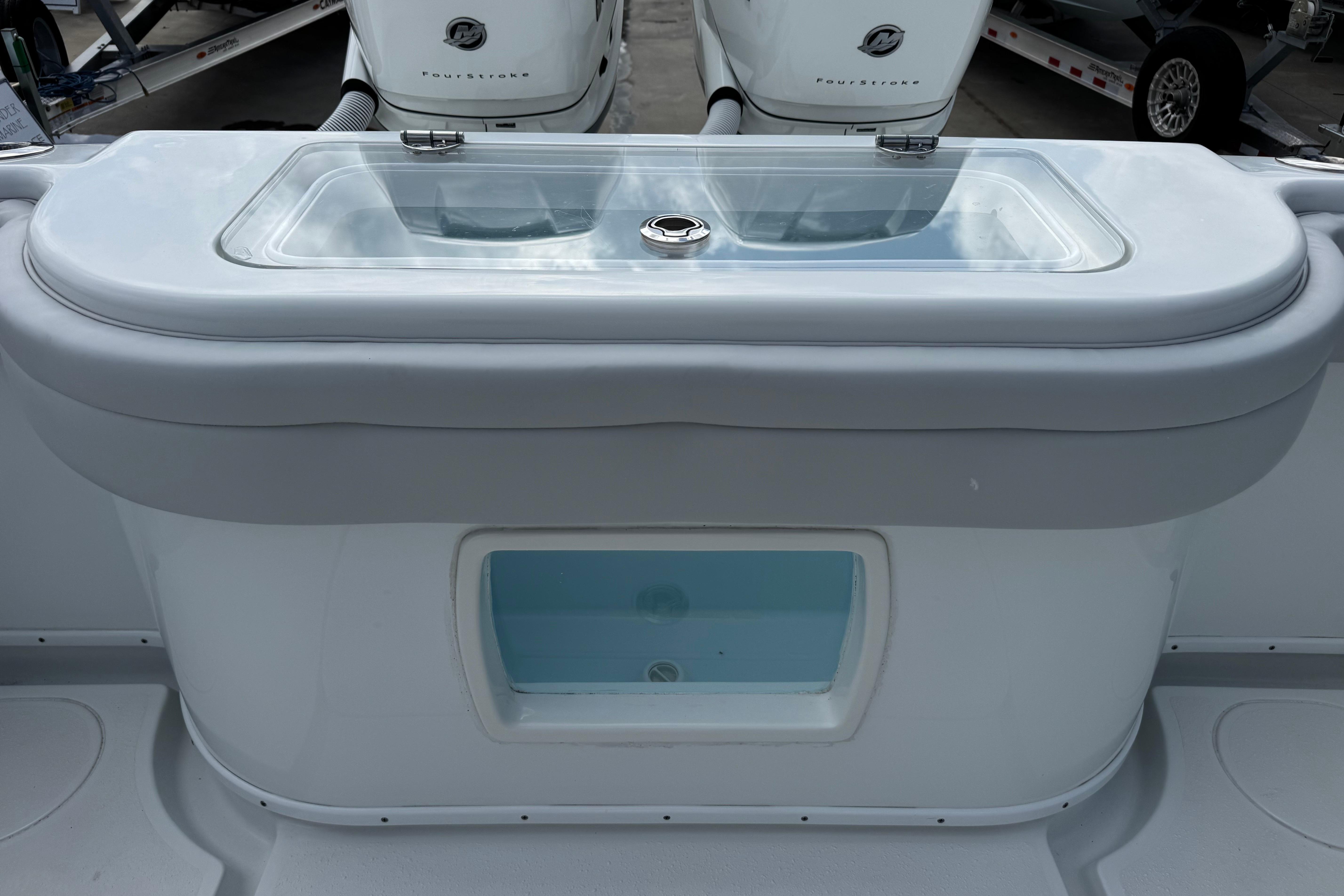 2022 Yellowfin 32 Offshore boat livewell with transparent lid and sleek design.
