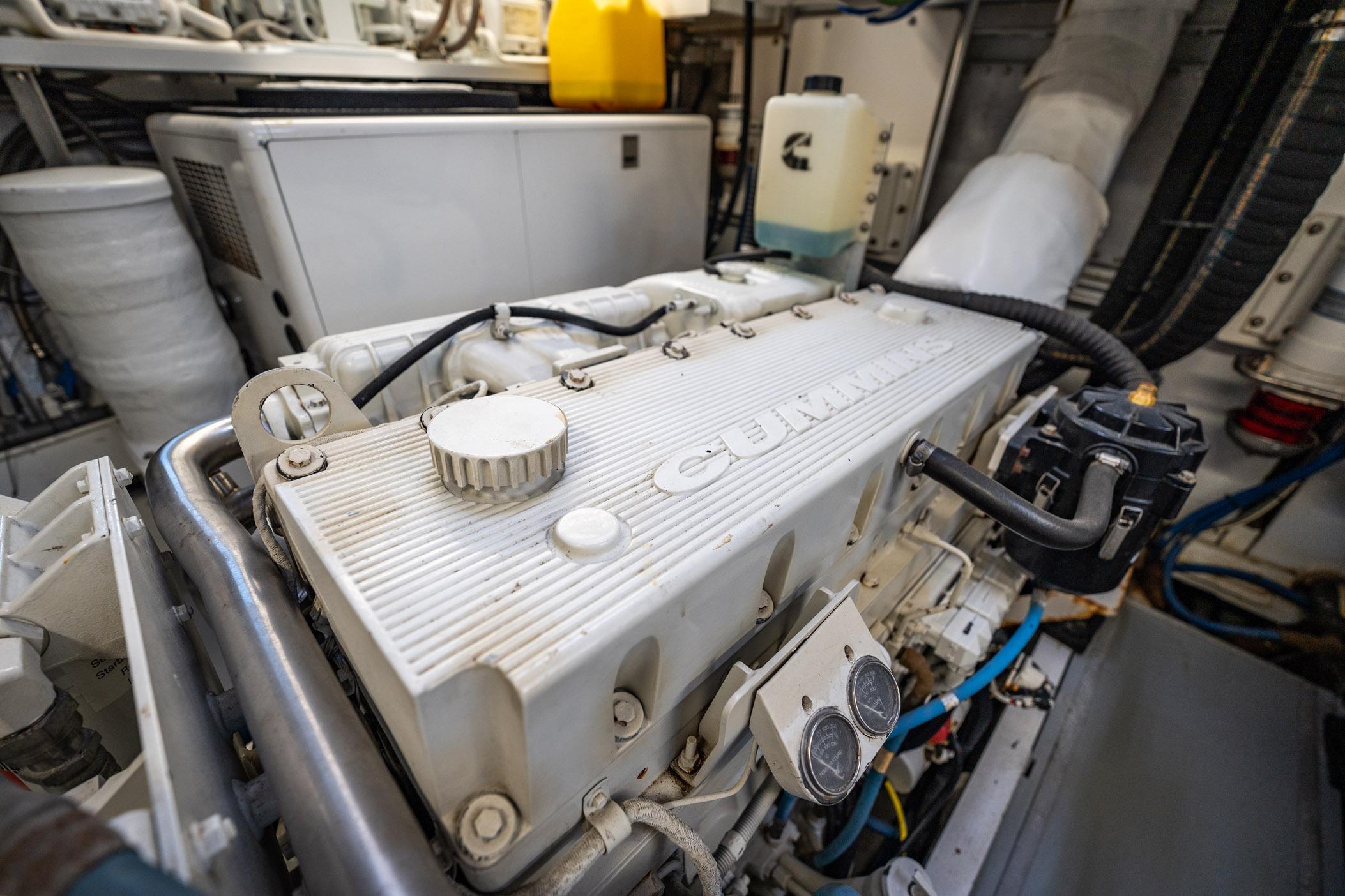 Engine room of a 1972 Trumpy 72 Motor Yacht featuring a Cummins engine.
